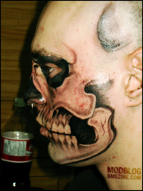  man with a "Misfits Crimson Skull" facial tattoo 