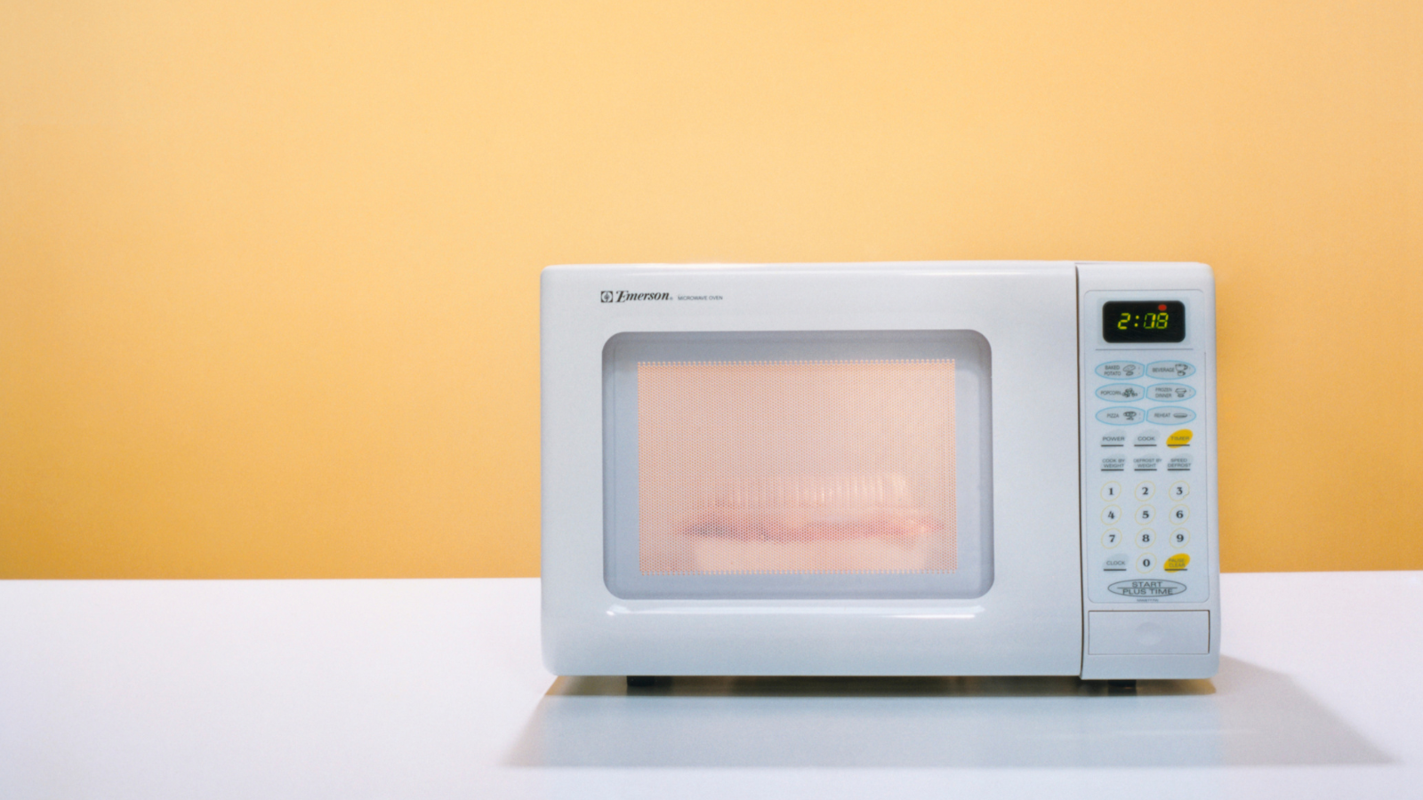 Does microwaving foods in plastic containers release cancer-causing agents into the foods?