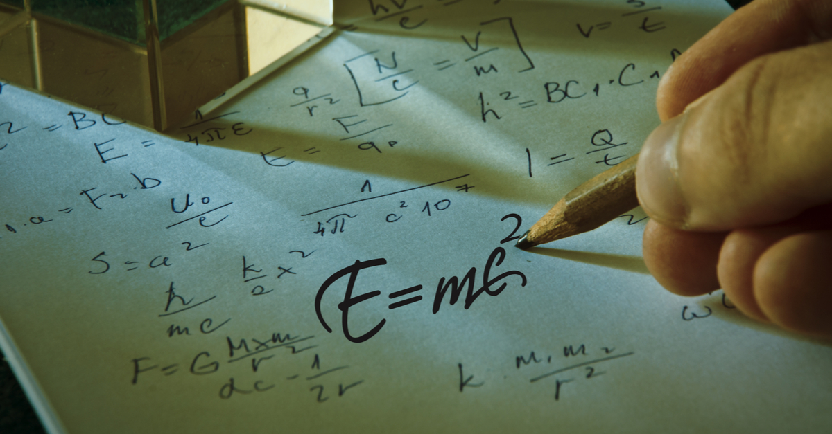 Hand writing out "E=mc squared."