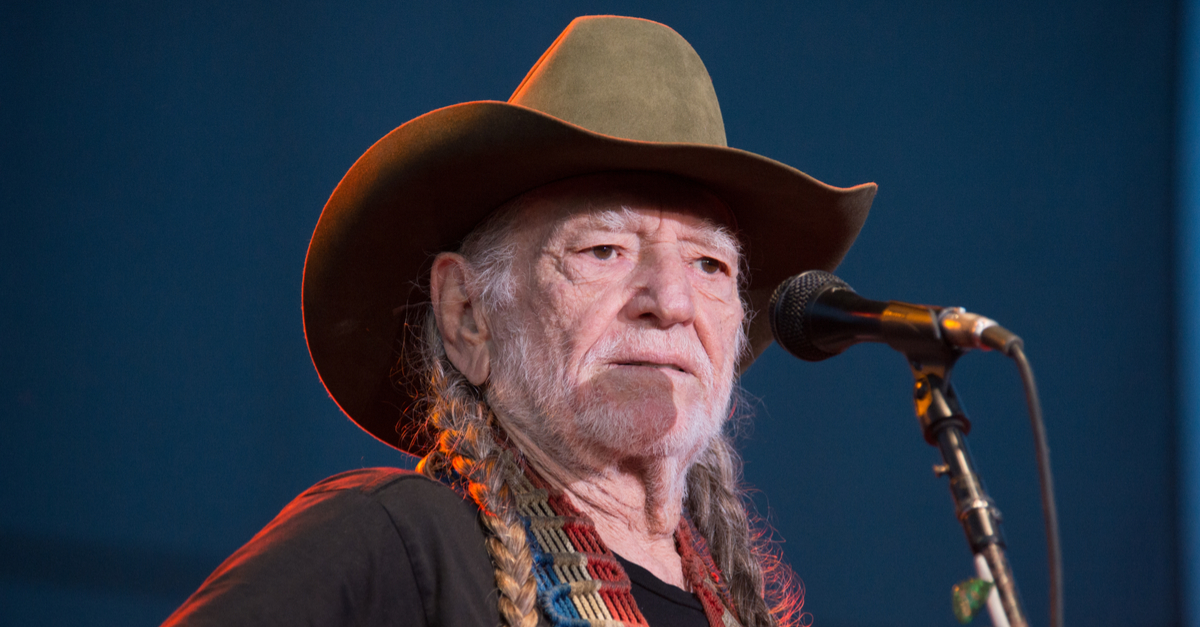 Willie Nelson in front of a microphone