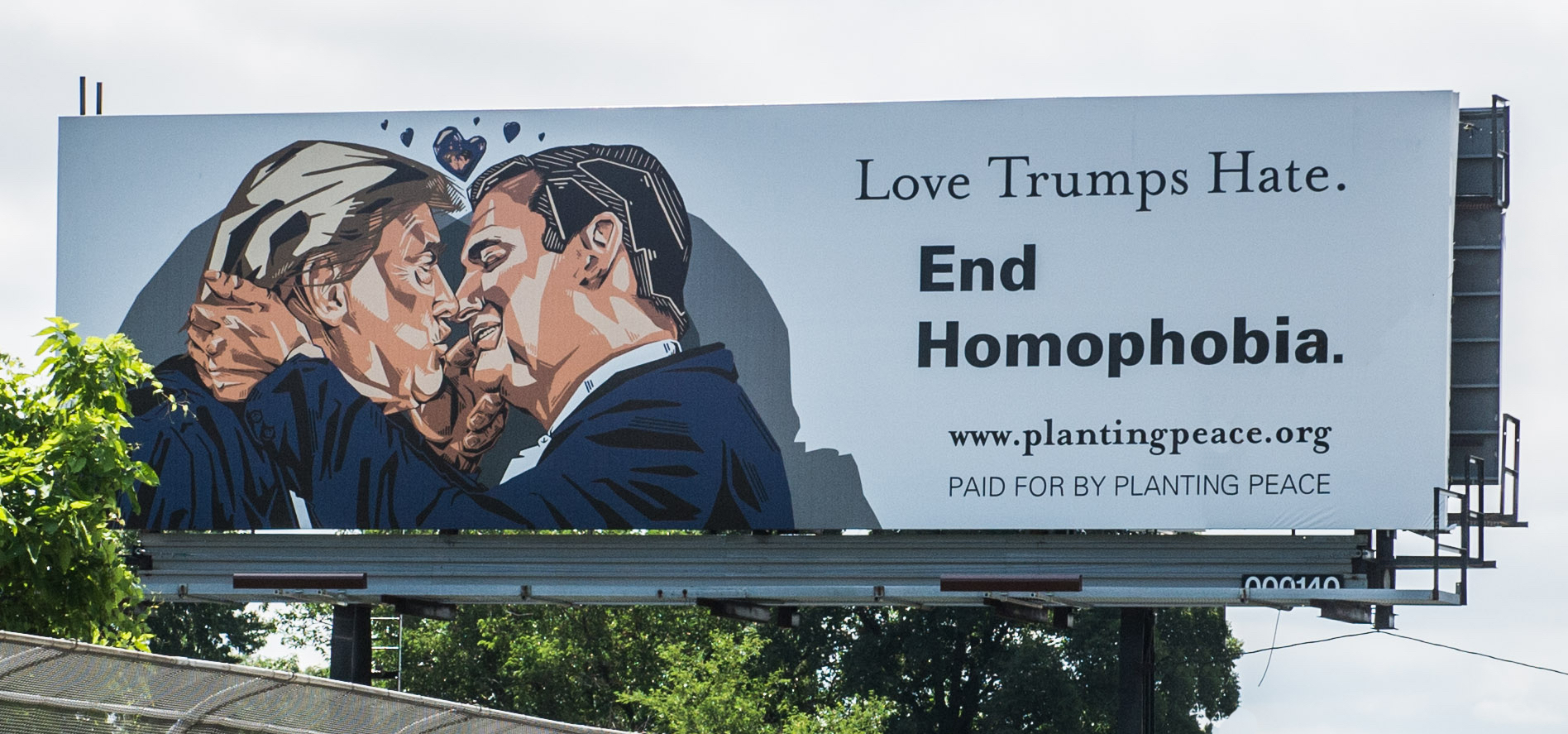 Billboard shows Donald Trump and Ted Cruz kissing.
