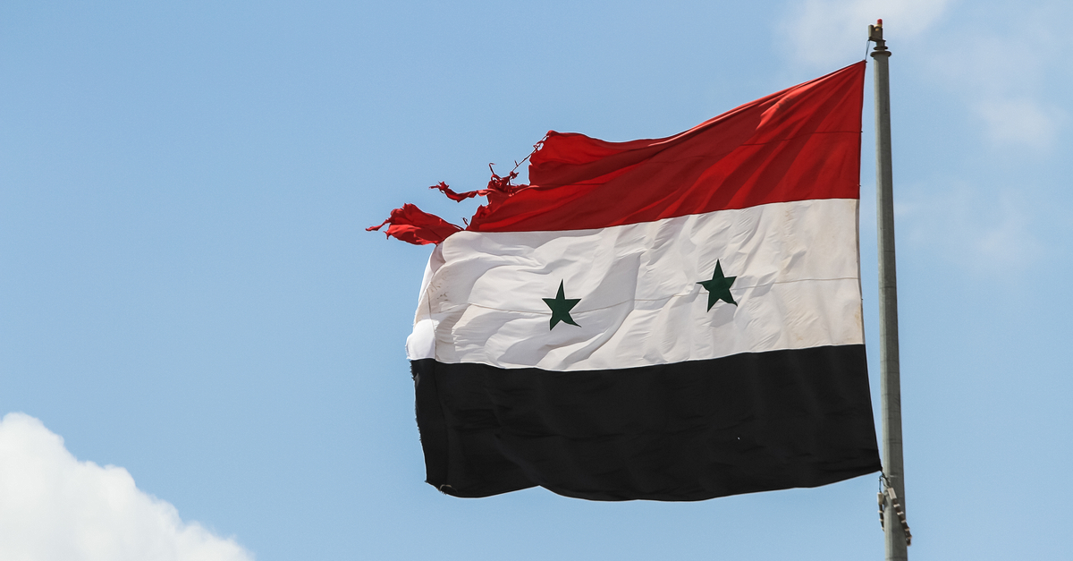 Tattered Syrian Arab Republic flag.
