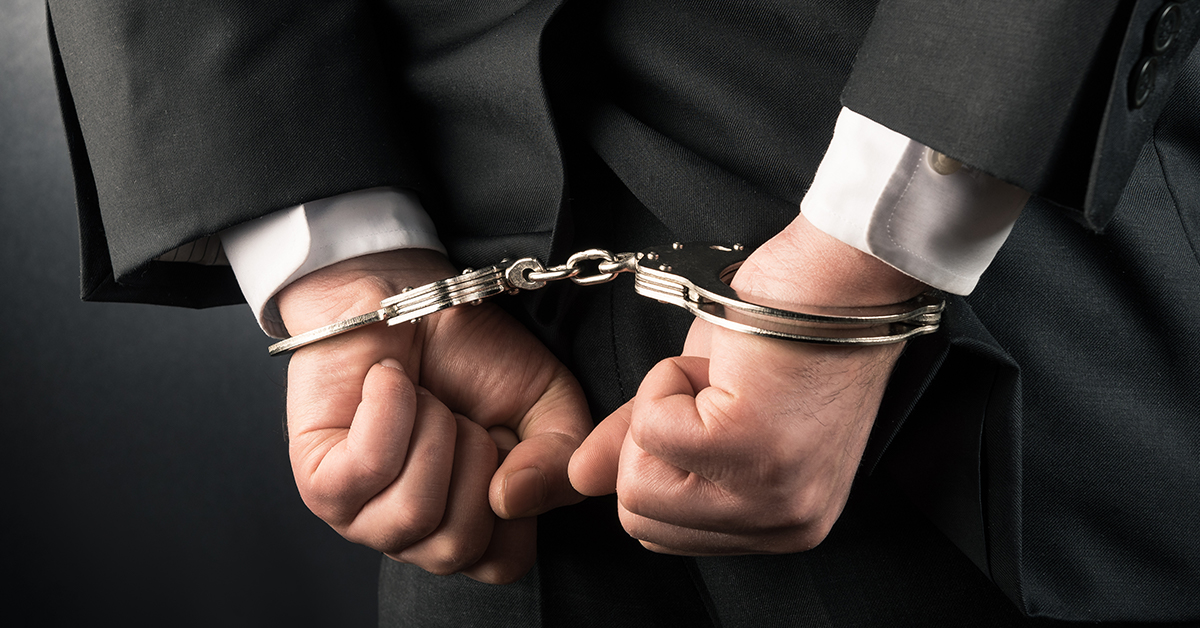 Close-up of a pair of hands in handcuffs.