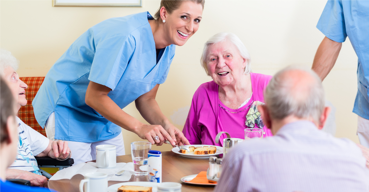 Nurse helping elderly with food