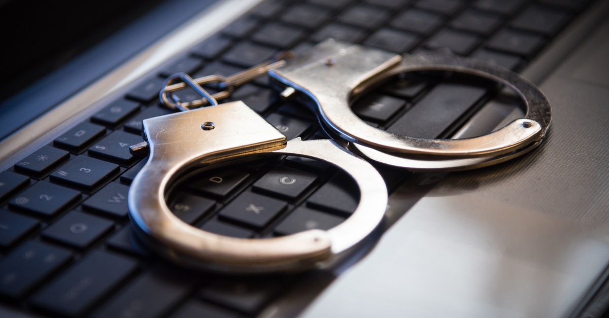 A pair of handcuffs on a keyboard.