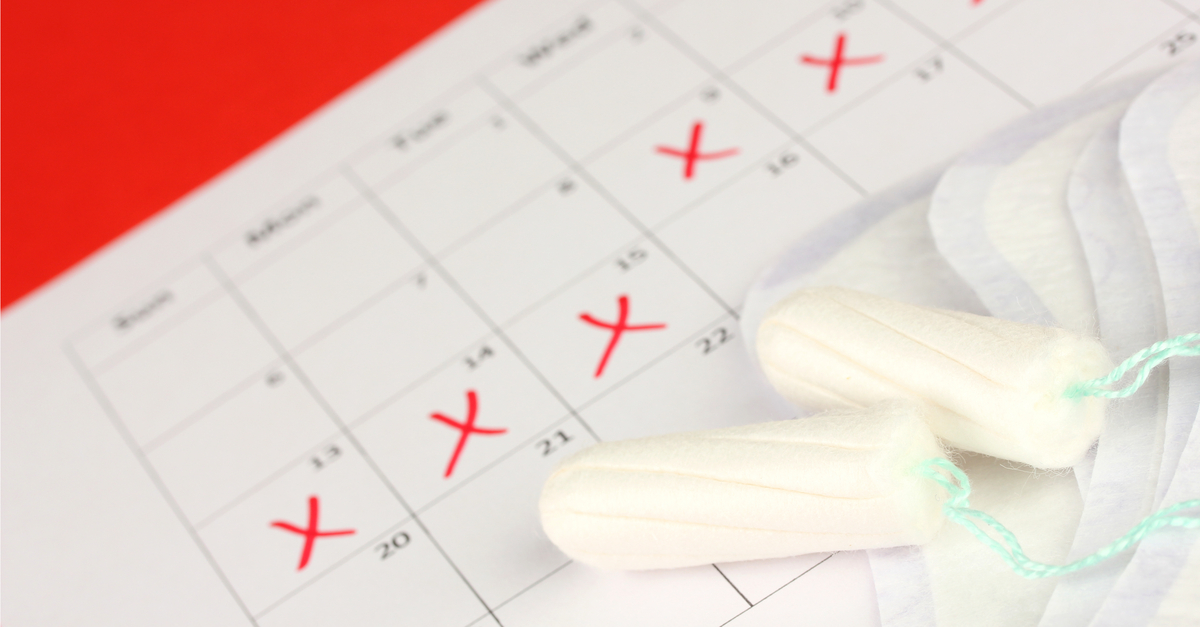 Calendar with marked days and tampons in foreground