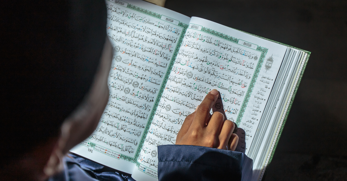 Muslim child reading Quran