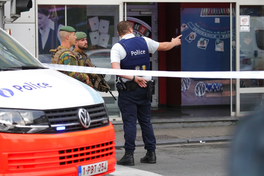 Brussels police say they opened fire on a vehicle after a high-speed chase in the suburb of Molenbeek; a driver told officers there were explosives inside.