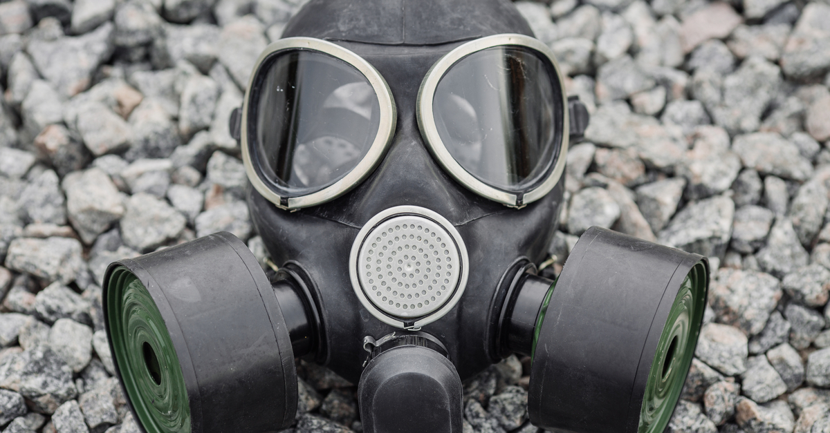 Gas mask sitting on rocky background