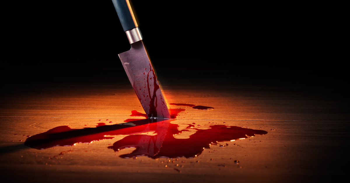 bloody knife stuck in wooden floor