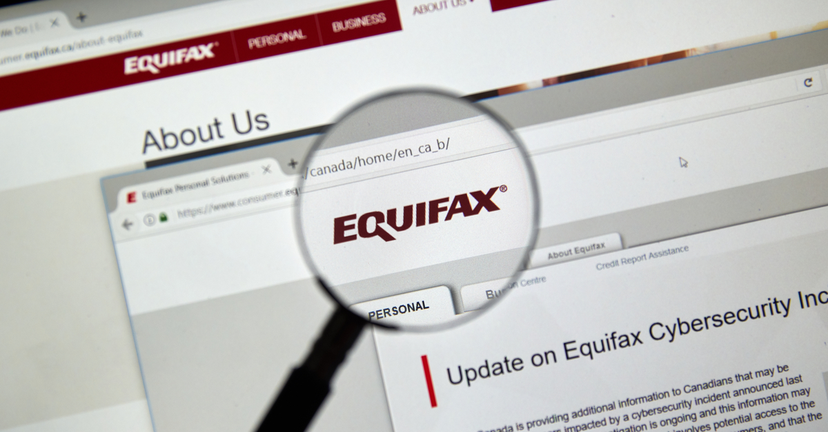 Computer screen with magnifying glass over the word "Equifax"
