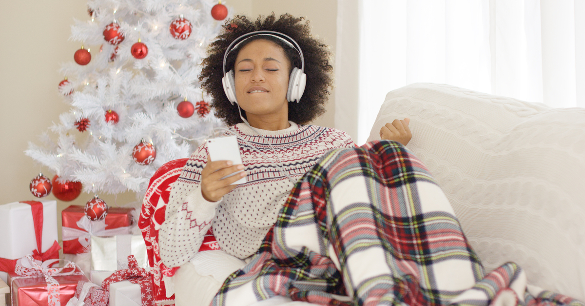 Woman listening to music in Christmas decorated room