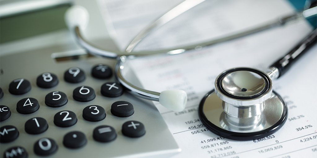 Calculator and stethoscope on financial statement concept for finance health check or cost of healthcare