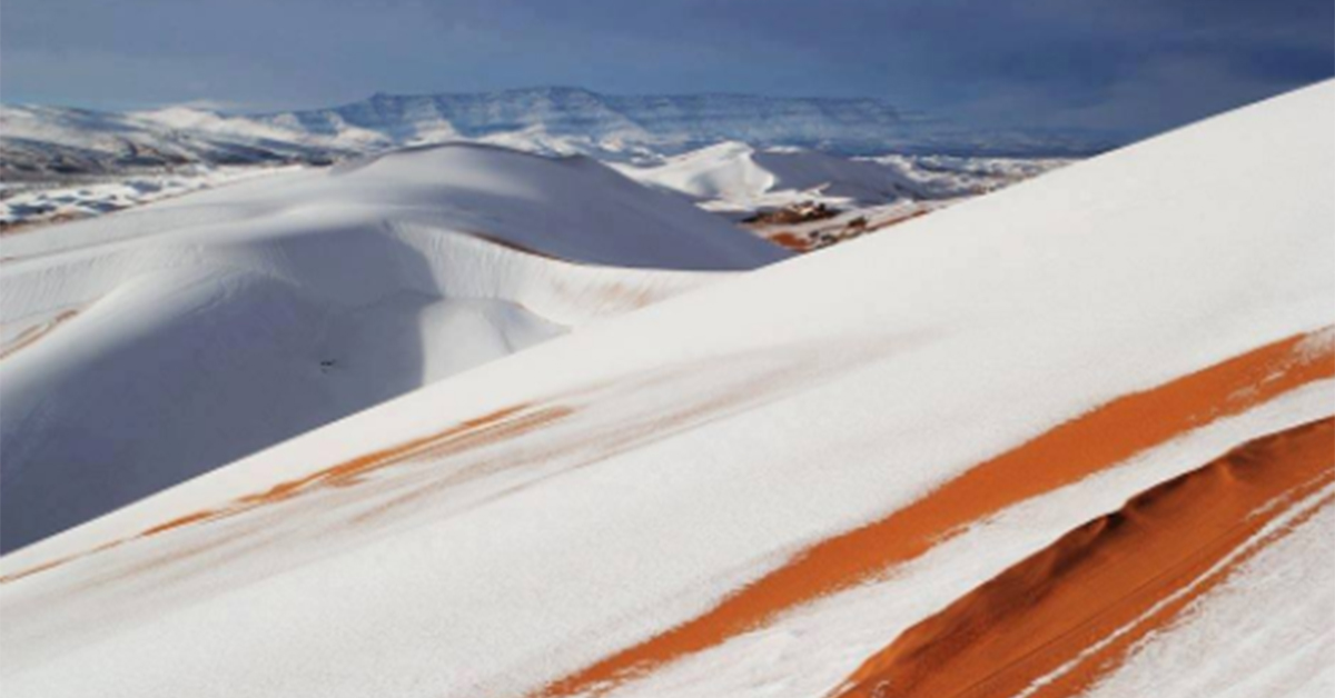 Snow-covered sand dunes in the Sahara Desert.