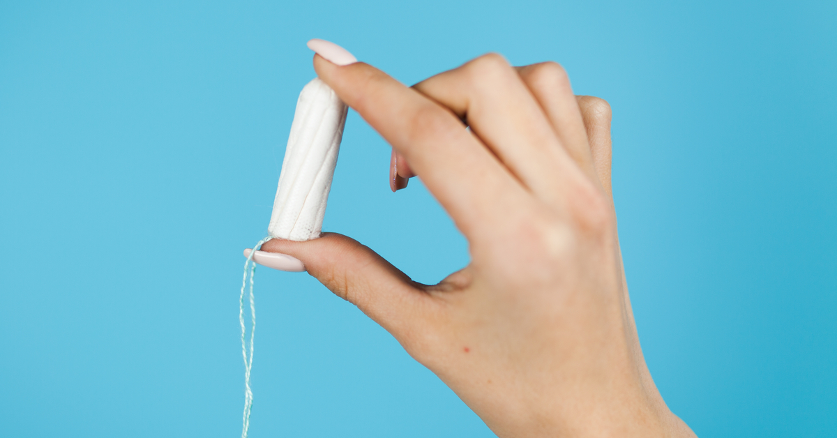 Hand holding a tampon.