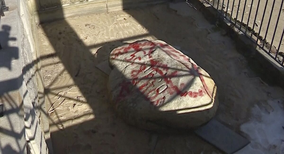 Vandals Cover Plymouth Rock In Red Graffiti