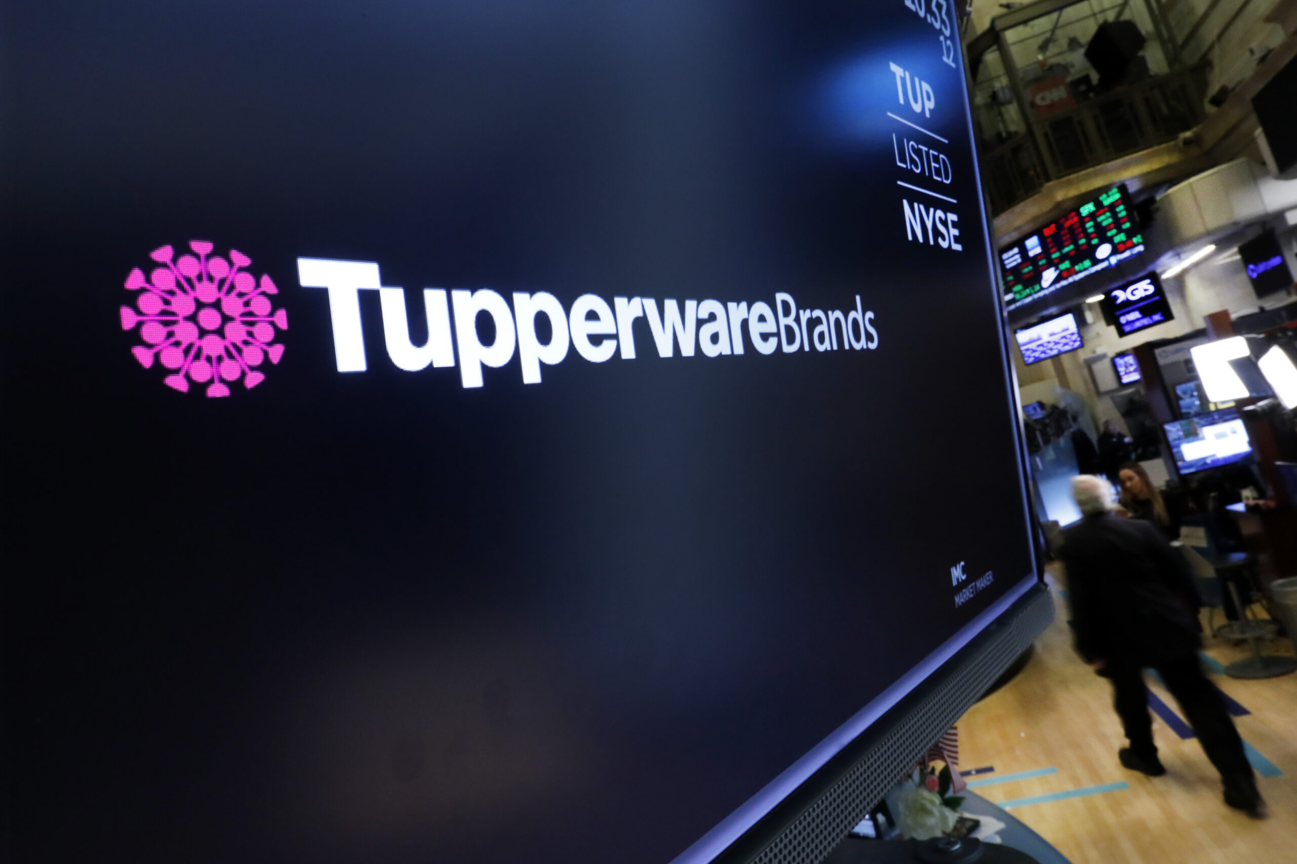 FILE - In this Oct. 30, 2019 file photo, the logo for Tupperware Brands appears above a trading post on the floor of the New York Stock Exchange. Tupperware Brands, on Wednesday, Oct. 28, 2020, posted third quarter profit of $34.4 million, more than quadruple the $7.8 million from the same quarter a year ago. (AP Photo/Richard Drew)