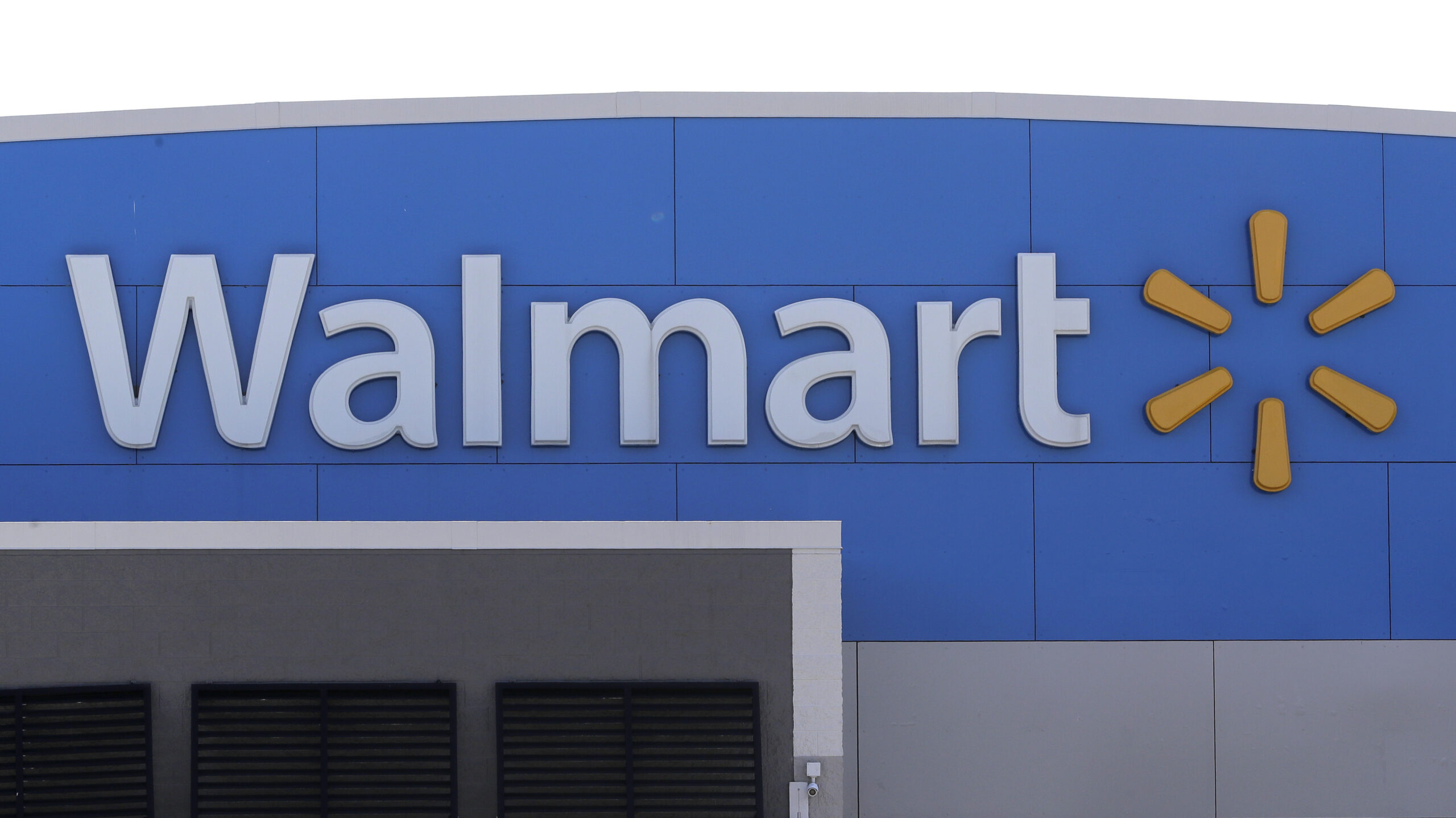 FILE - In this Tuesday, Sept. 3, 2019, file photo, A Walmart logo is attached to the outside of a Walmart store in Walpole, Mass. Walmart says it has removed ammunition and firearms from displays at U.S. stores, citing “civil unrest” in some areas. The nation’s largest retailer, based in Bentonville, Arkansas, sell firearms in about half of its 4,700 stores. (AP Photo/Steven Senne, File)