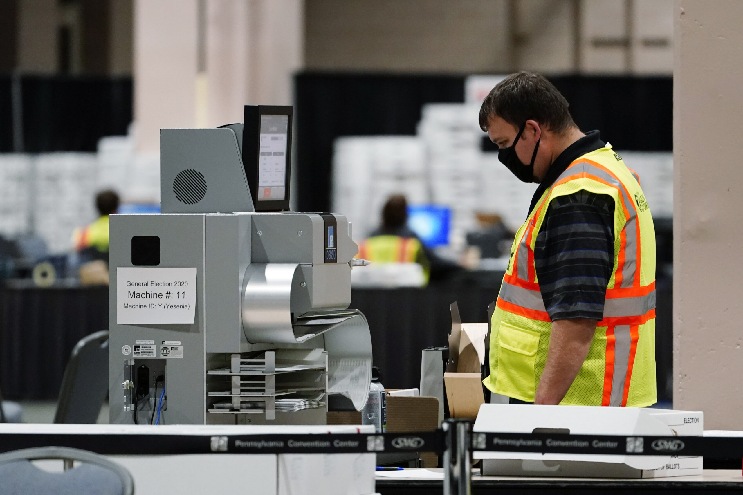 A Philadelphia election worker scans ballots for the 2020 general election in the United States at the Pennsylvania Convention Center, Tuesday, Nov. 3, 2020, in Philadelphia. (AP Photo/Matt Slocum)