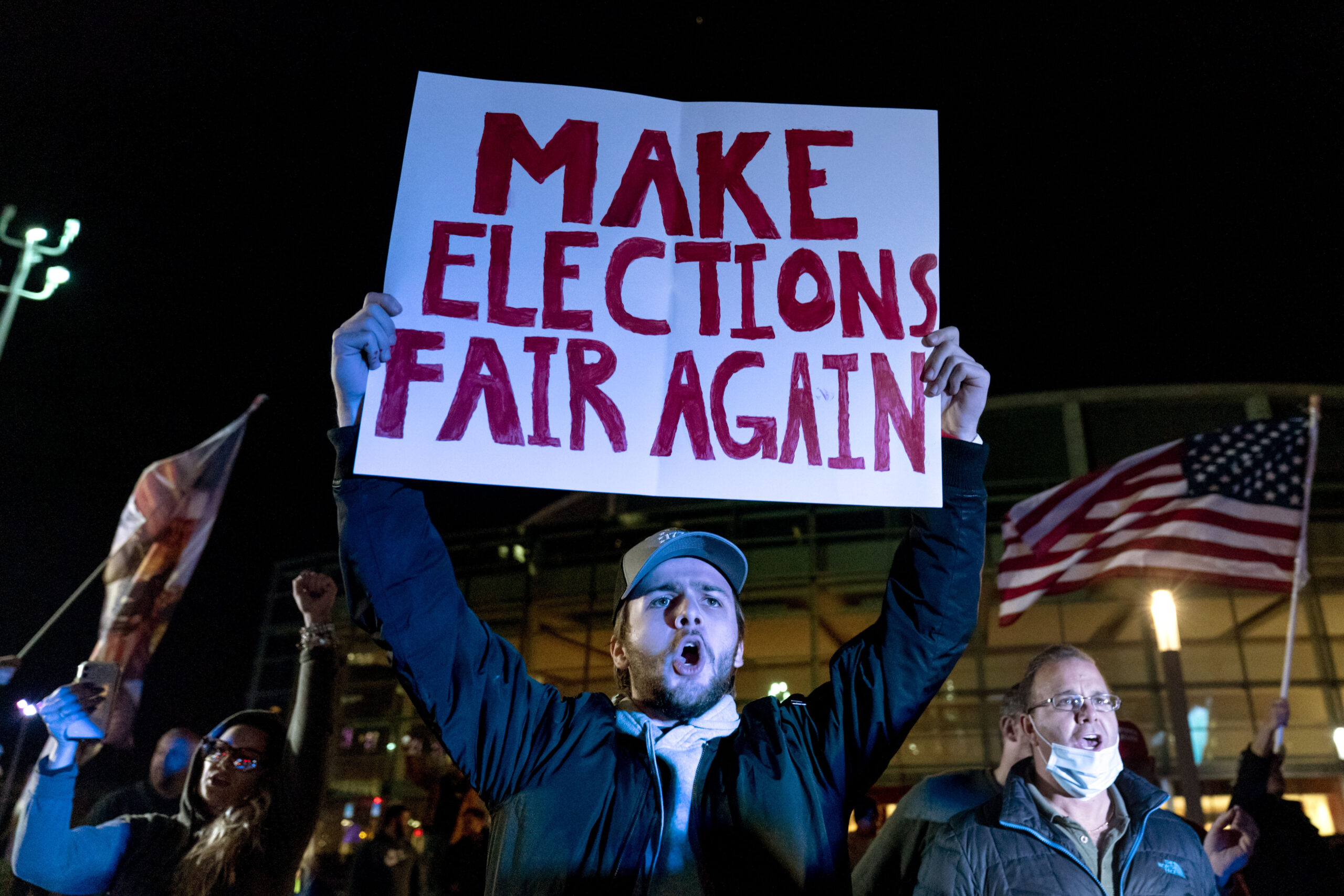 FILE - In this Nov. 5, 2020, file photo, Jake Contos, a supporter of President Donald Trump, chants during a protest against the election results outside the central counting board at the TCF Center in Detroit. President Donald Trump and his allies have fomented the idea of a “rigged election” for months, promoting falsehoods through various media and even lawsuits about fraudulent votes and dead voters casting ballots. While the details of these spurious allegations may fade over time, the scar it leaves on American democracy could take years to heal. (AP Photo/David Goldman, File)
