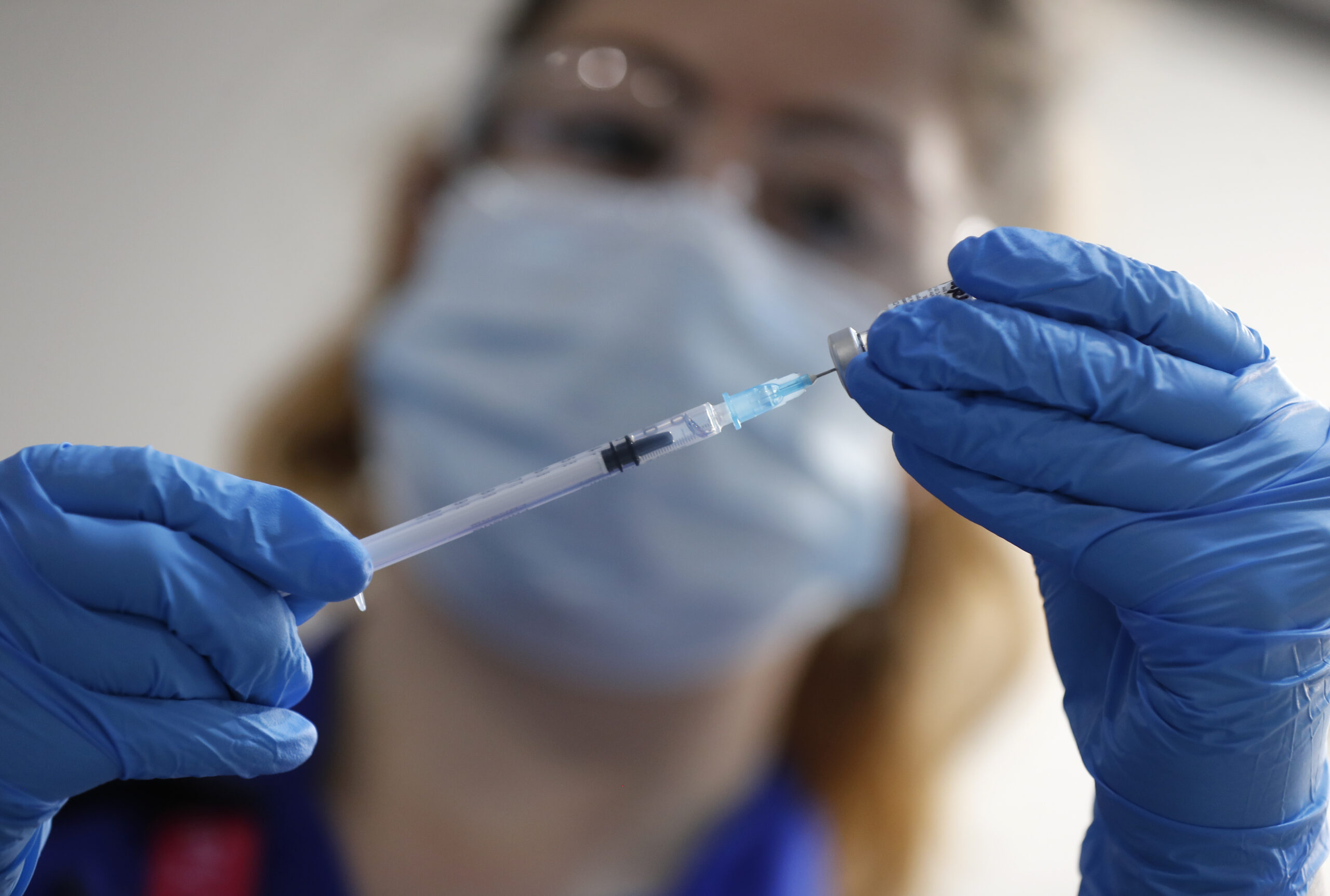 A nurse prepares a shot of the Pfizer-BioNTech COVID-19 vaccine at Guy's Hospital in London, Tuesday, Dec. 8, 2020, as the U.K. health authorities rolled out a national mass vaccination program. U.K. regulators said Wednesday Dec. 9, 2020, that people who have a “significant history’’ of allergic reactions shouldn’t receive the new Pfizer/BioNTech vaccine while they investigate two adverse reactions that occurred on the first day of the country’s mass vaccination program. (AP Photo/Frank Augstein, Pool)