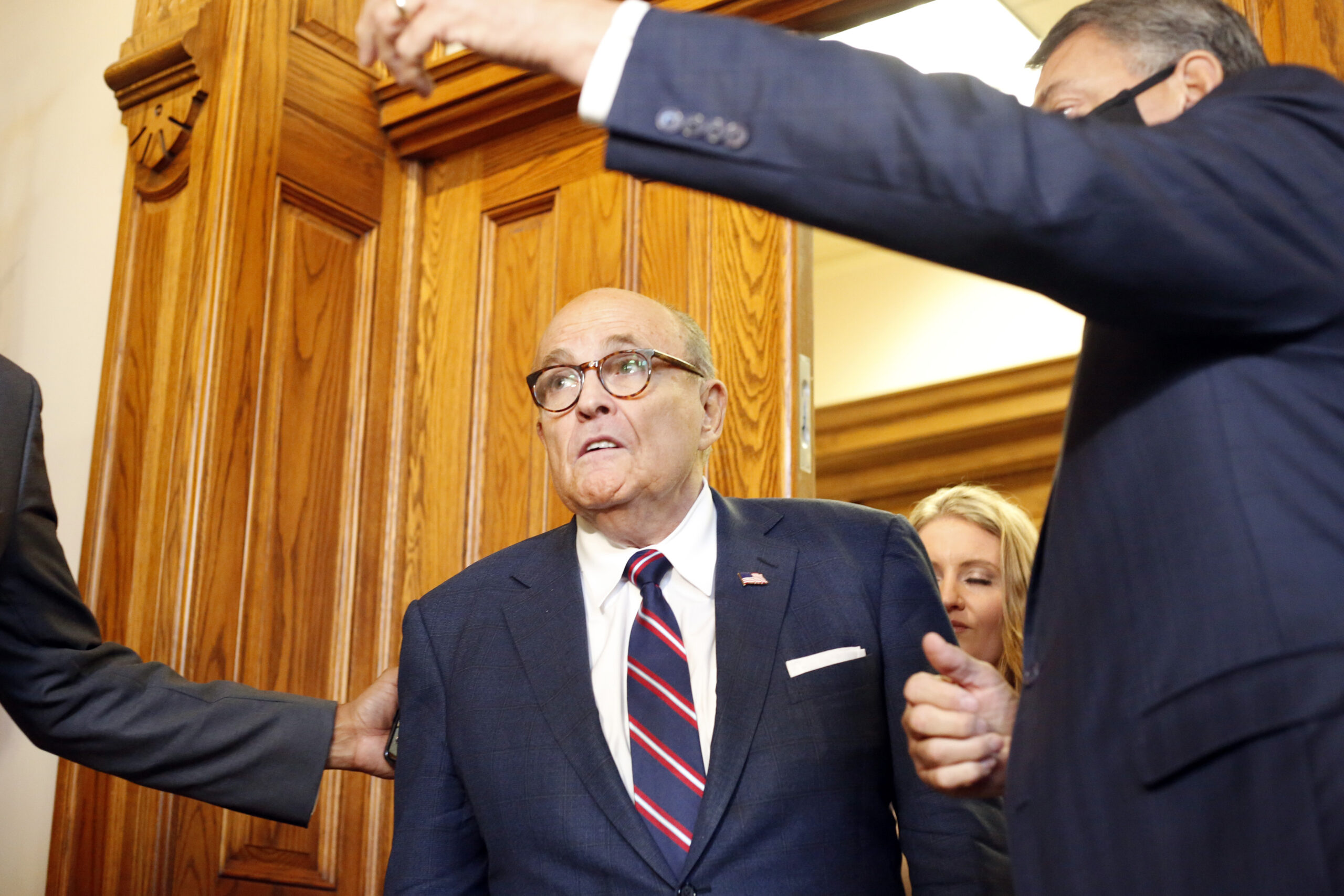 Rudy Giuliani walks to a senate hearing at the Georgia State Capitol in Atlanta on Thursday, December 3, 2020. The Georgia Senate Committee on Judiciary has formed a special subcommittee to take testimony of elections improprieties and evaluate the election process. (Rebecca Wright/Atlanta Journal-Constitution via AP)