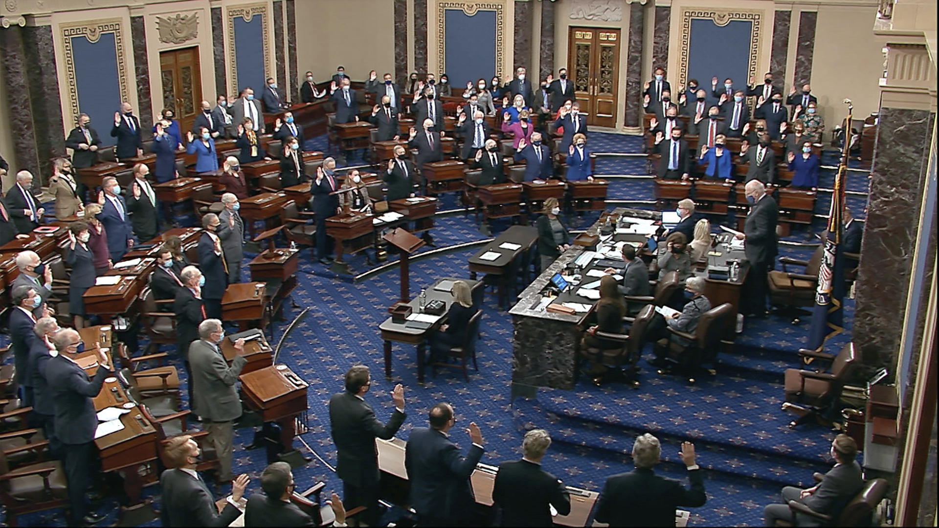 In this image from video, Sen. Patrick Leahy, D-Vt., the president pro tempore of the Senate, who is presiding over the impeachment trial of former President Donald Trump, swears in members of the Senate for the impeachment trial at the U.S. Capitol in Washington, Tuesday, Jan. 26, 2021. (Senate Television via AP)