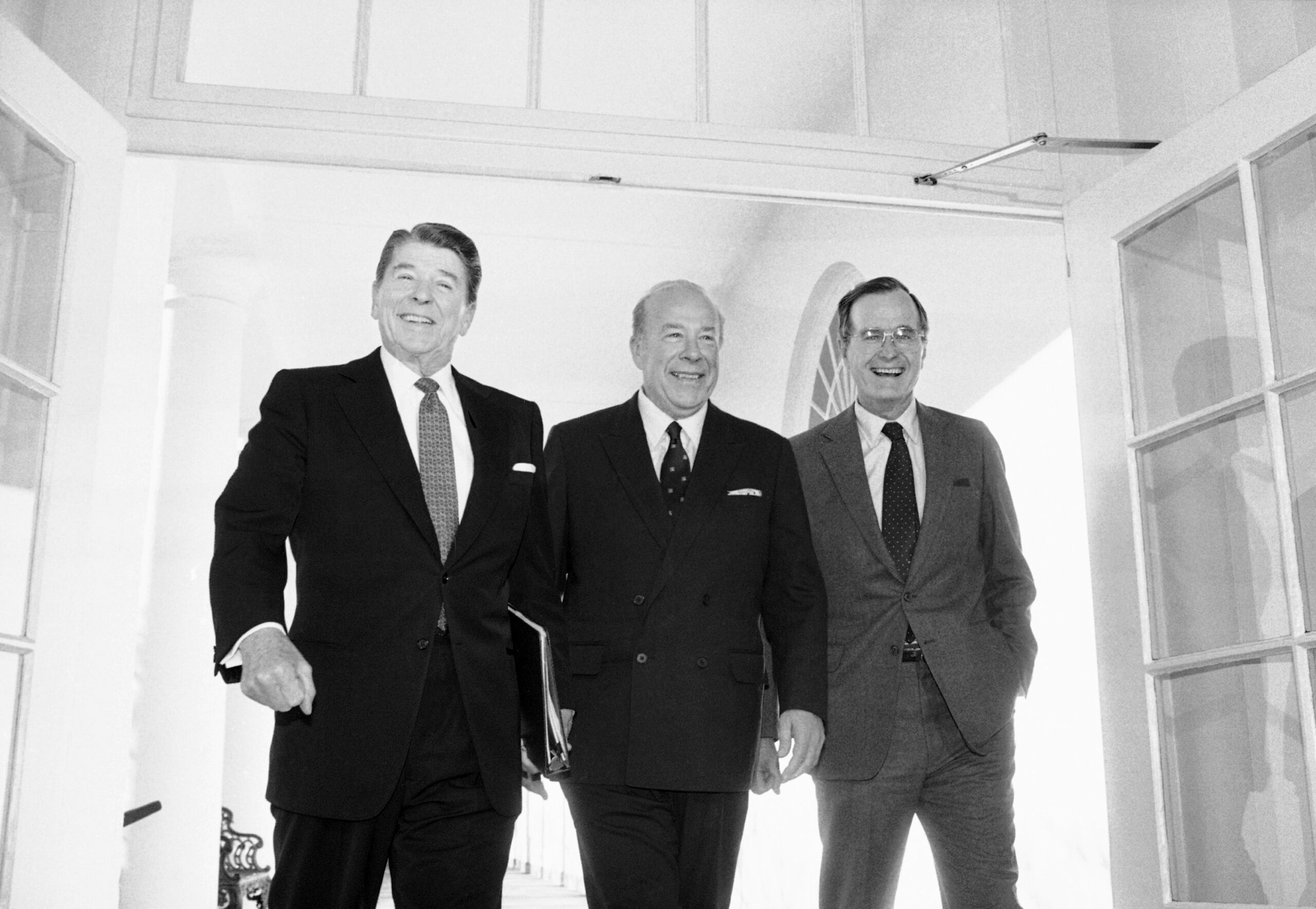 FILE - In this Jan. 9, 1985 file photo, Secretary of State George Shultz, center, walks with President Ronald Reagan and Vice President George Bush upon his arrival at the White House in Washington, after two days of arms talks with the Soviet Union in Geneva. Shultz, former President Reagan's longtime secretary of state, who spent most of the 1980s trying to improve relations with the Soviet Union and forging a course for peace in the Middle East, died Saturday, Feb. 6, 2021. He was 100. (AP Photo/Barry Thumma, File)