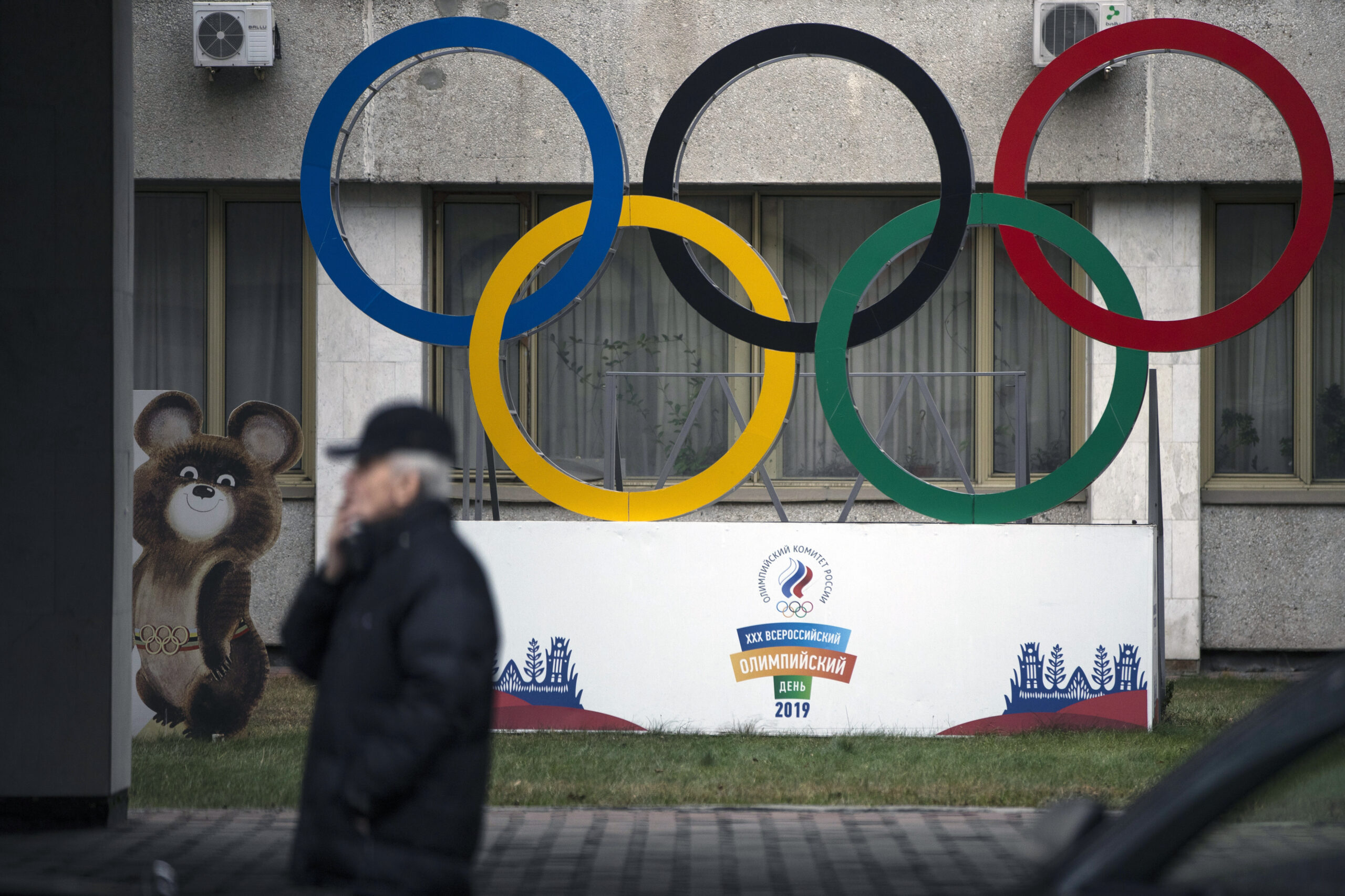 FILE - In this Nov. 28, 2019 file photo Olympic Rings and a model of Misha the Bear Cub, the mascot of the Moscow 1980 Olympic Games, left, are seen in the yard of Russian Olympic Committee building in Moscow, Russia. In the report detailing its decision to shorten Russia's ban from the Olympics, the highest court in sports blasted that country's leaders for engaging in “a cover up of the cover-up” in a desperate attempt to deny their culpability, but reduced the punishment nonetheless, Wednesday, Jan. 13, 2021. (AP Photo/Pavel Golovkin, file)