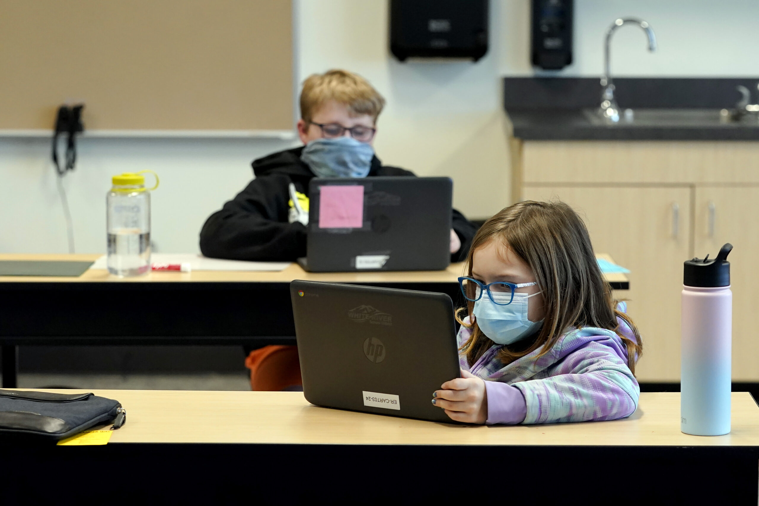 FILE - In this Feb. 2, 2021, file photo, students wear masks as they work in a fourth-grade classroom, at Elk Ridge Elementary School in Buckley, Wash. Amid mounting tensions about school reopening, the Centers for Disease Control and Prevention planned to release long-awaited guidance Friday, Feb. 12, 2021, on what measures are needed to get children back into the classroom during the pandemic. (AP Photo/Ted S. Warren, File)