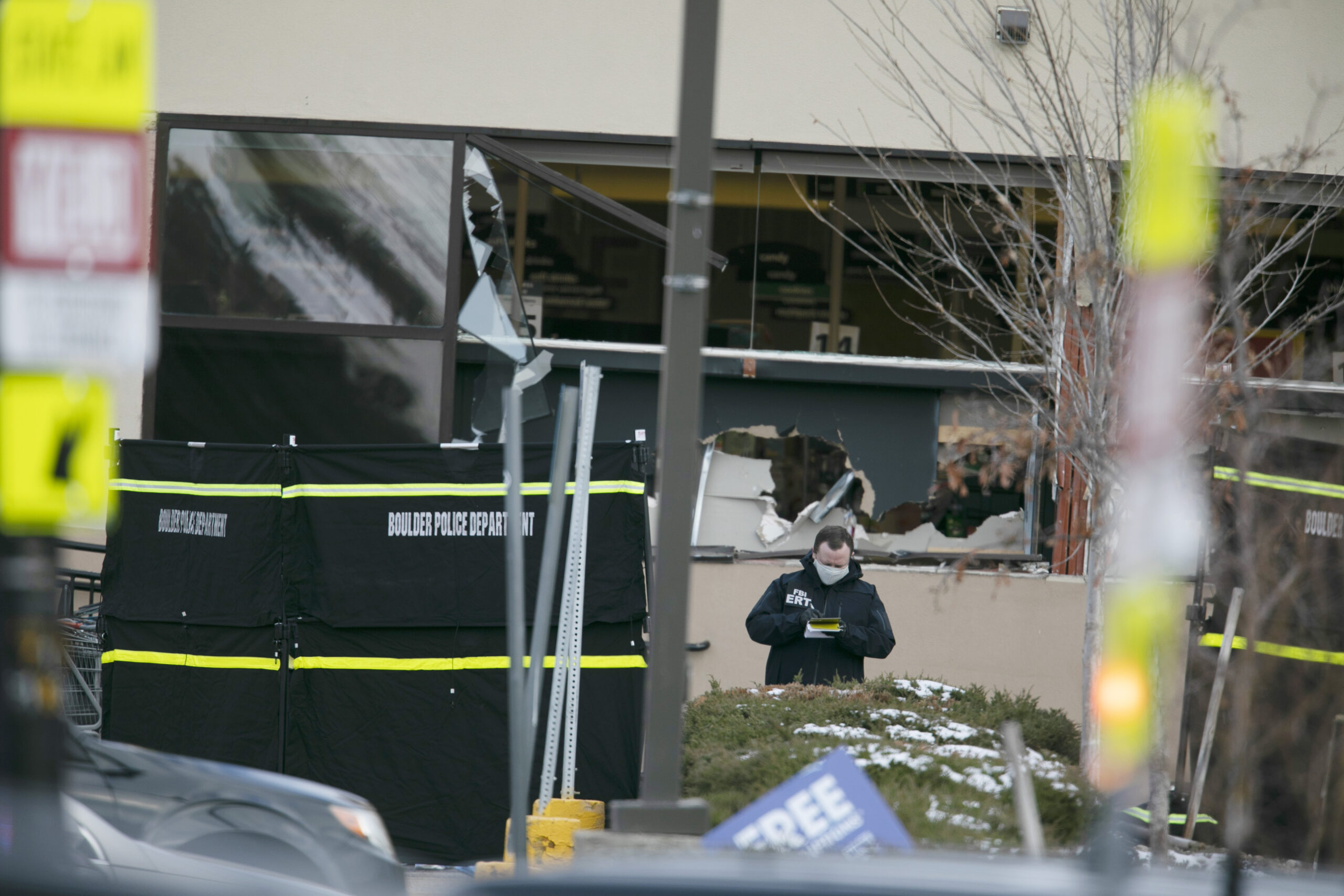 Police work on the scene outside of a King Soopers grocery store where authorities say multiple people were killed in a shooting, Monday, March 22, 2021, in Boulder, Colo.. (AP Photo/Joe Mahoney)