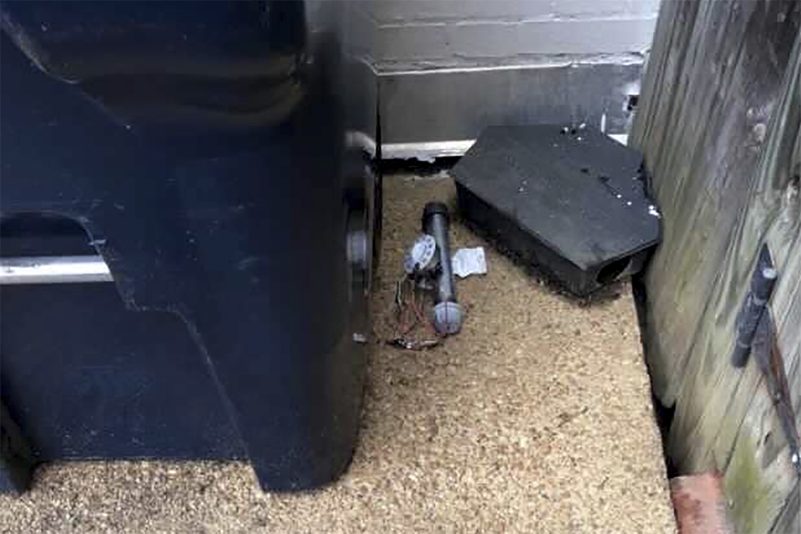 In this Jan. 6, 2021 photo, an explosive device is shown outside of the Republican National Committee office in Washington. The FBI has released new video showing someone placing two pipe bombs outside the offices of the Republican and Democratic national committees the night before the Jan. 6 riot at the U.S. Capitol. (AP Photo)
