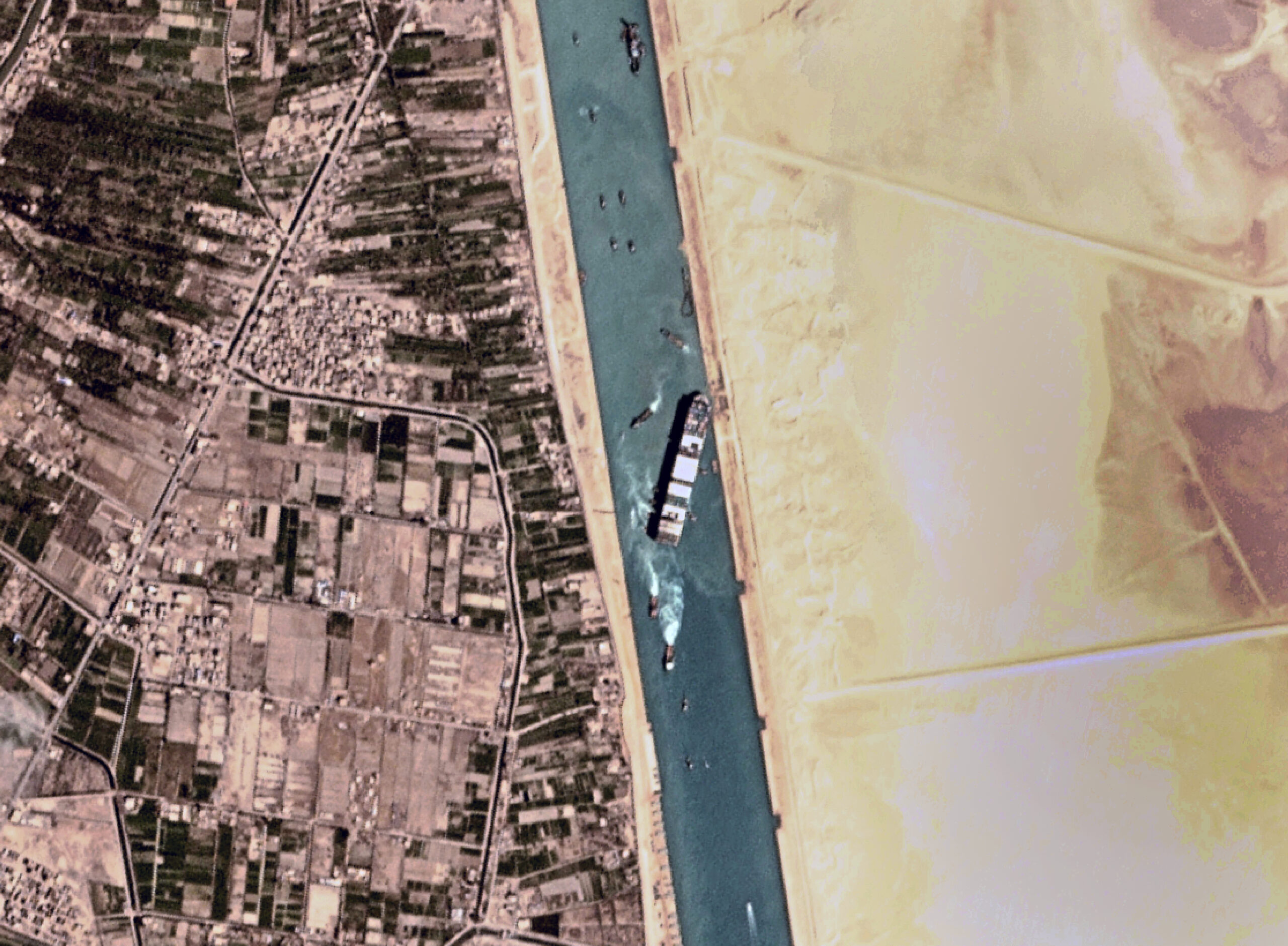 This satellite photo from Planet Labs Inc. shows the Ever Given cargo ship stuck in Egypt's Suez Canal Monday, March 29, 2021. Engineers on Monday "partially refloated" the colossal container ship that continues to block traffic through the Suez Canal, authorities said, without providing further details about when the vessel would be set free. (Planet Labs Inc. via AP)