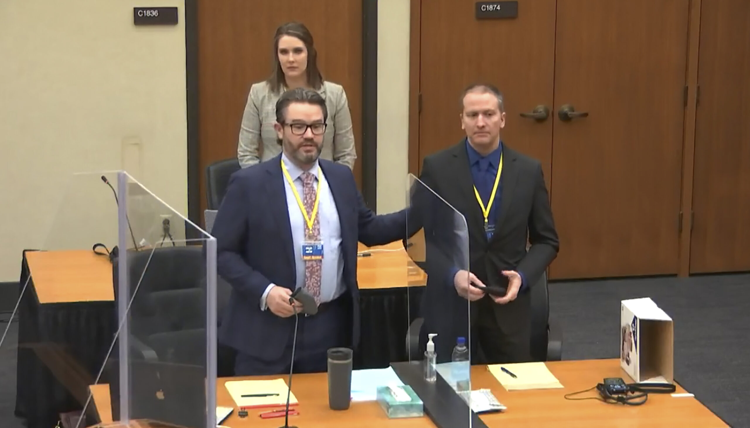In this screen grab from video, defense attorney Eric Nelson, left, defendant and former Minneapolis police officer Derek Chauvin, right, and Nelson's assistant Amy Voss, back, introduce themselves to potential jurors as Hennepin County Judge Peter Cahill Tuesday, March 23, 2021, presides over jury selection in the trial of Chauvin at the Hennepin County Courthouse in Minneapolis, Minn. Chauvin is charged in the May 25, 2020 death of George Floyd. (Court TV, via AP, Pool)