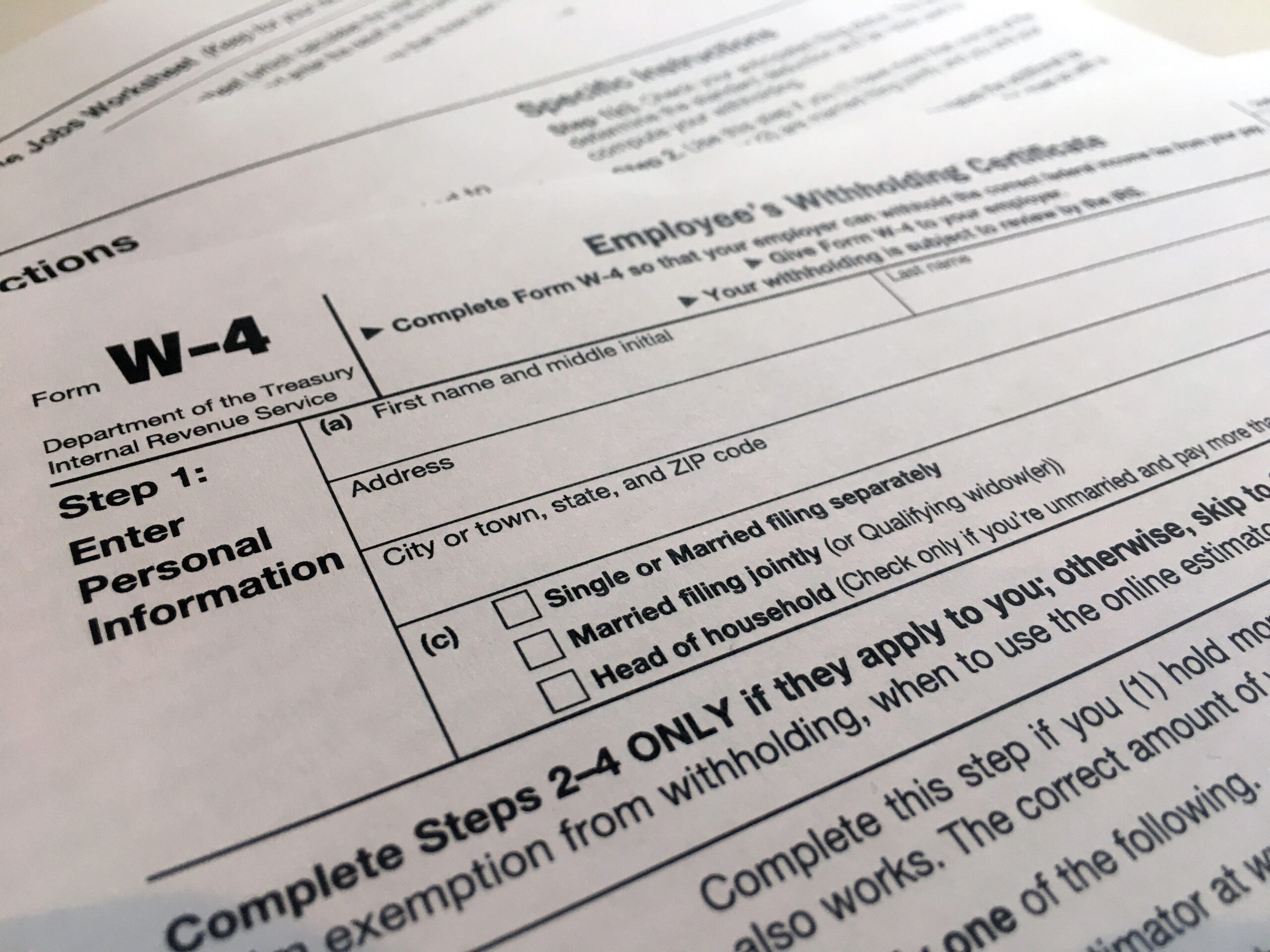 FILE - In this Feb. 5, 2020, file photo, a W-4 form is viewed in New York. The IRS will delay the traditional April 15 tax filing due date until May 17, 2021, to cope with added duties and provide Americans more flexibility. (AP Photo/Patrick Sison, File)