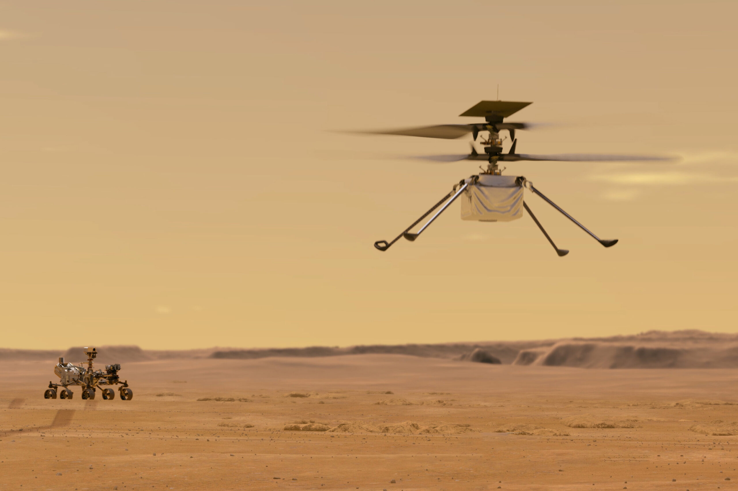 FILE - This illustration made available by NASA depicts the Ingenuity helicopter on Mars which was attached to the bottom of the Perseverance rover, background left. It will be the first aircraft to attempt controlled flight on another planet. (NASA/JPL-Caltech via AP)
