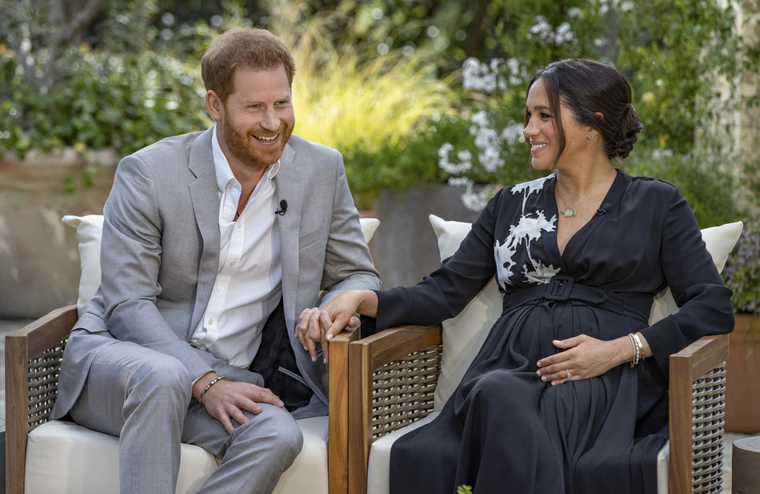 This image provided by Harpo Productions shows Prince Harry, left, and Meghan, Duchess of Sussex, speaking about expecting their second child during an interview with Oprah Winfrey. "Oprah with Meghan and Harry: A CBS Primetime Special" airs March 7 as a two-hour exclusive primetime special on the CBS Television Network. (Joe Pugliese/Harpo Productions via AP)