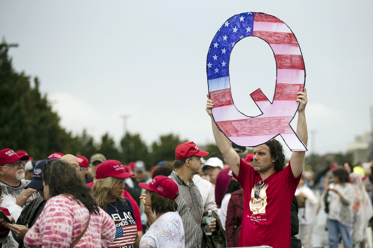 protesters holds a QAnon sign