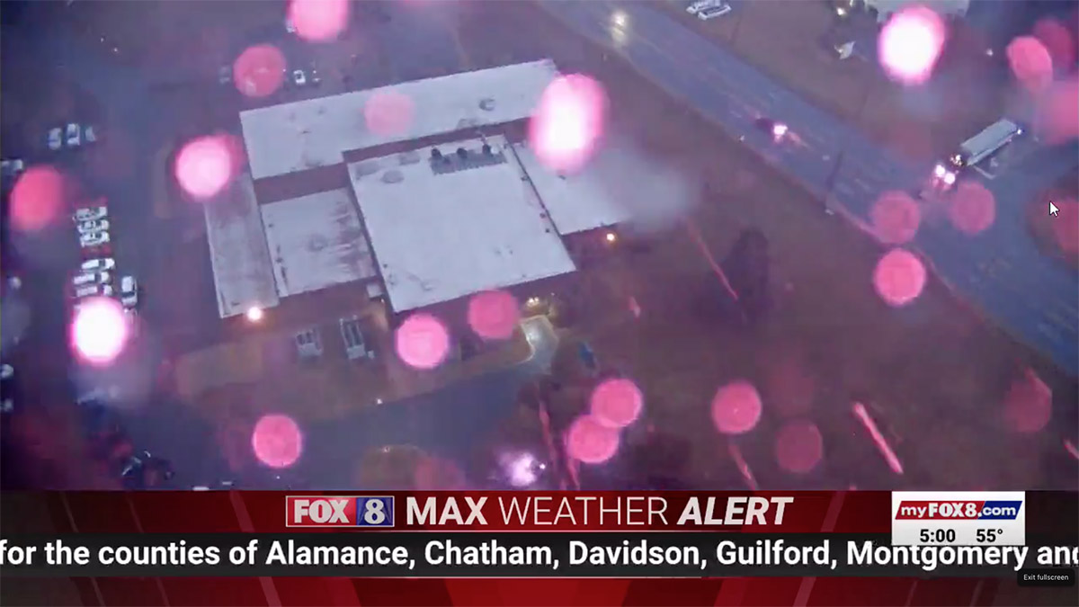A TV news crew scrambled to leave the studio during storms.