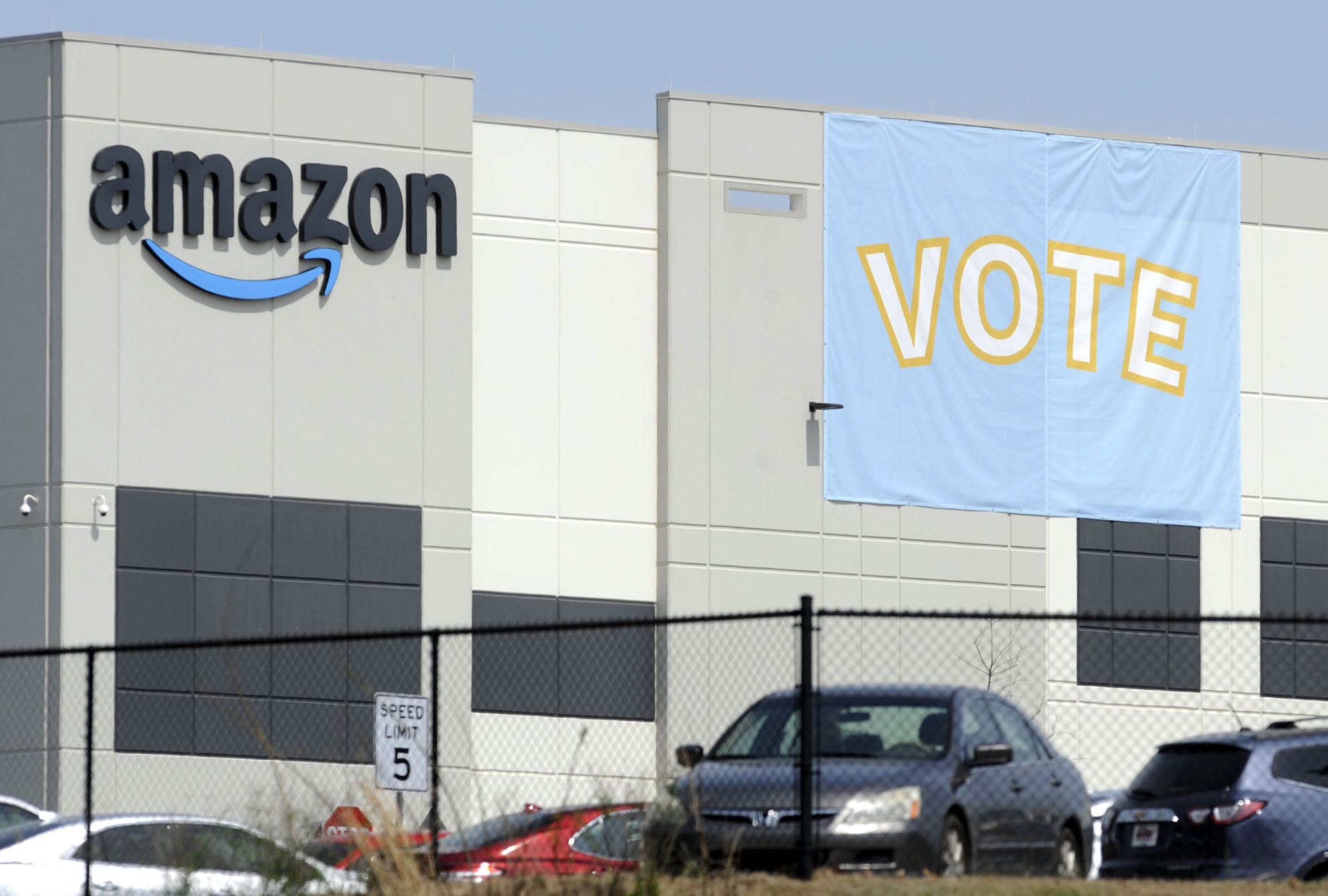 FILE - In this Tuesday, March 30, 2021 file photo, a banner encouraging workers to vote in labor balloting is shown at an Amazon warehouse in Bessemer, Ala. Vote counting in the union push in Bessemer is expected to start as early as Thursday, April 8, but hundreds of contested ballots could muddy the outcome if it’s a close race. (AP Photo/Jay Reeves, File)