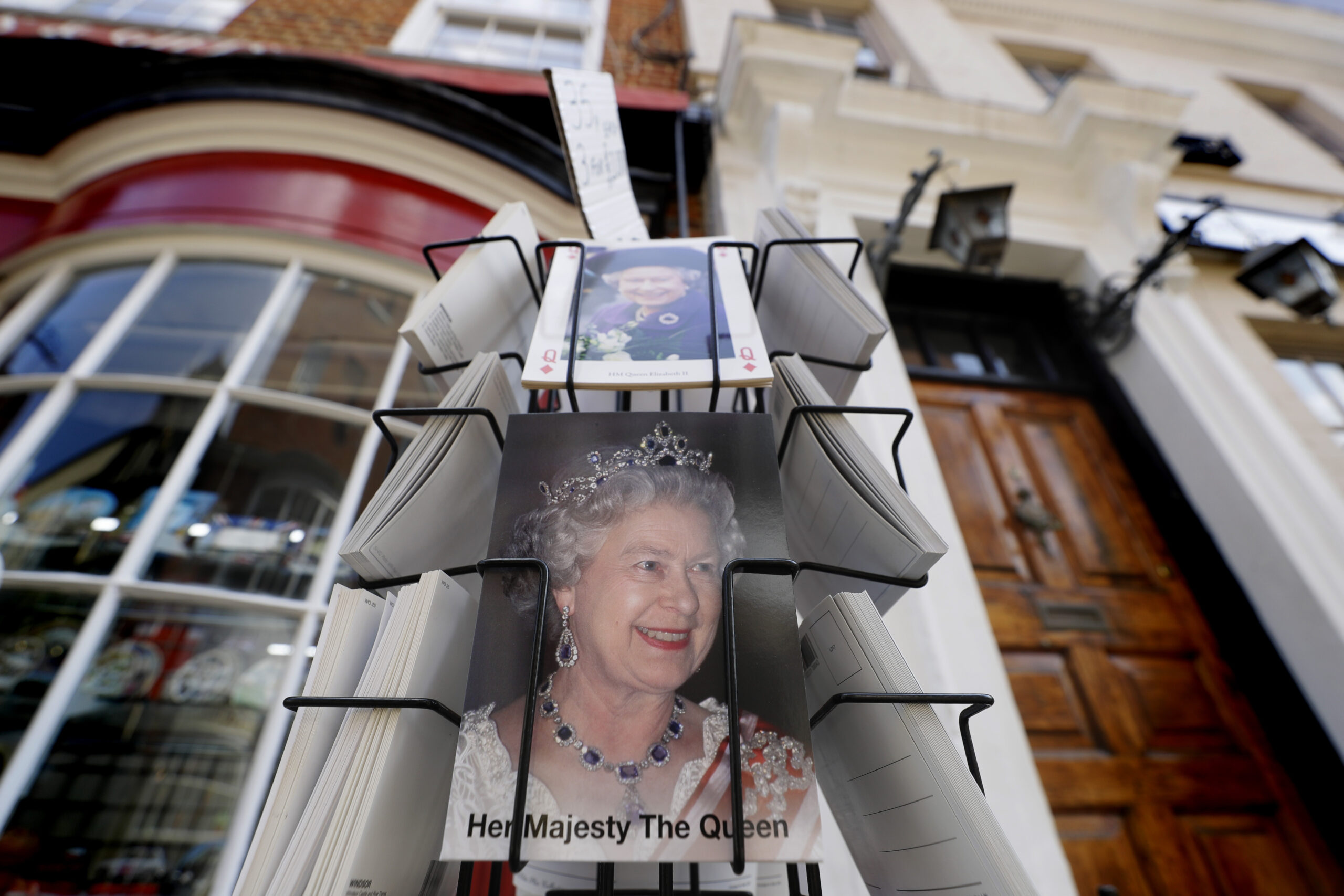 Postcards with pictures of Queen Elizabeth II for sale in Windsor, England Wednesday, April 21, 2021. Britain's Queen Elizabeth II is marking her 95th birthday in a low-key fashion at Windsor Castle, just days after the funeral of her husband Prince Philip. Some members of the royal family are expected to be with the queen on Wednesday. Her birthday falls within the two-week royal mourning period for Philip that is being observed until Friday. (AP Photo/Kirsty Wigglesworth)