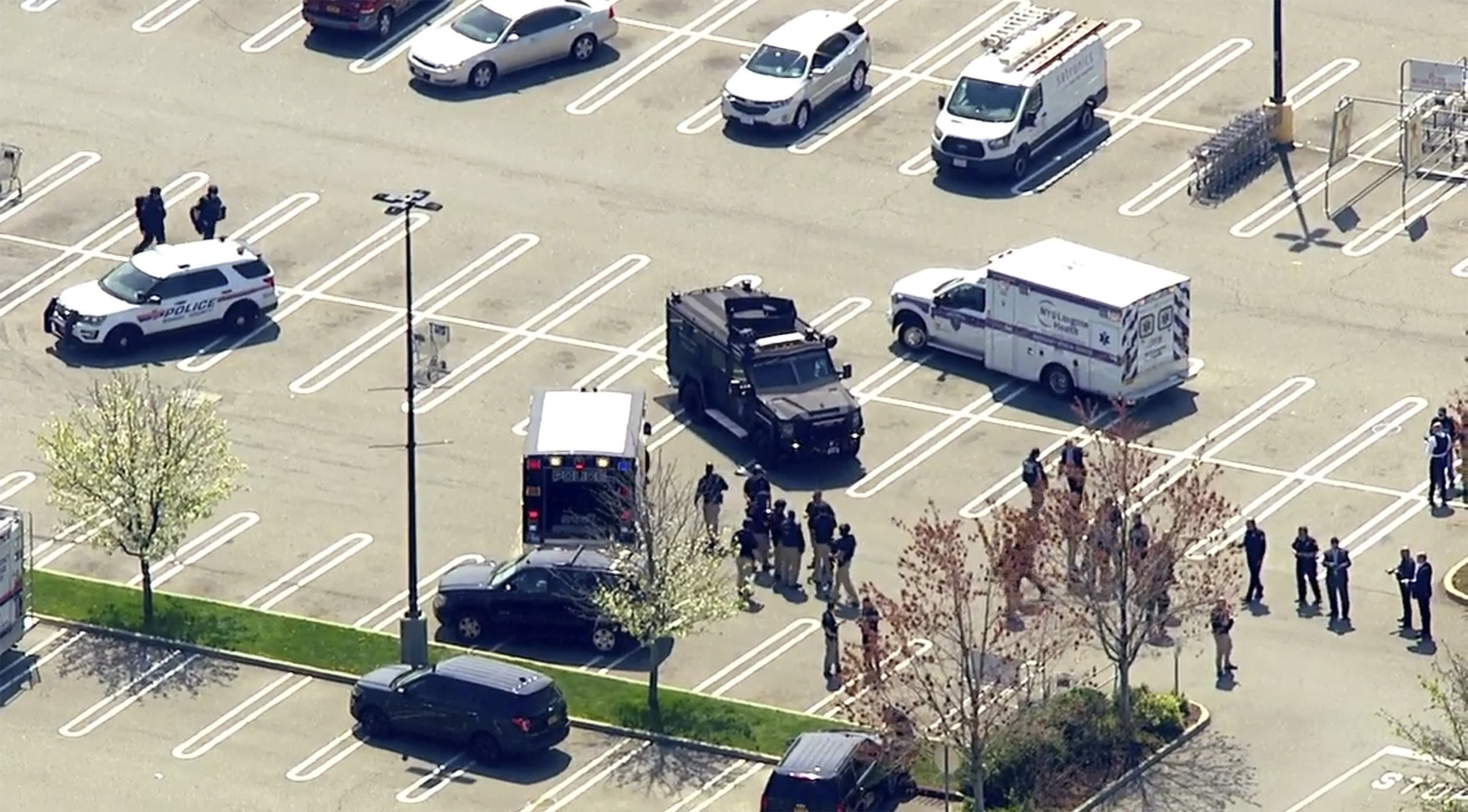 This aerial photo provided by WABC shows police responding to the scene of a shooting at a Stop & Shop supermarket in West Hempstead, N.Y., on Tuesday, April 20, 2021. Nassau County Executive Laura Curran said in a tweet Tuesday there had been shooting at the Long Island supermarket and that the suspect has not been apprehended. (WABC via AP)