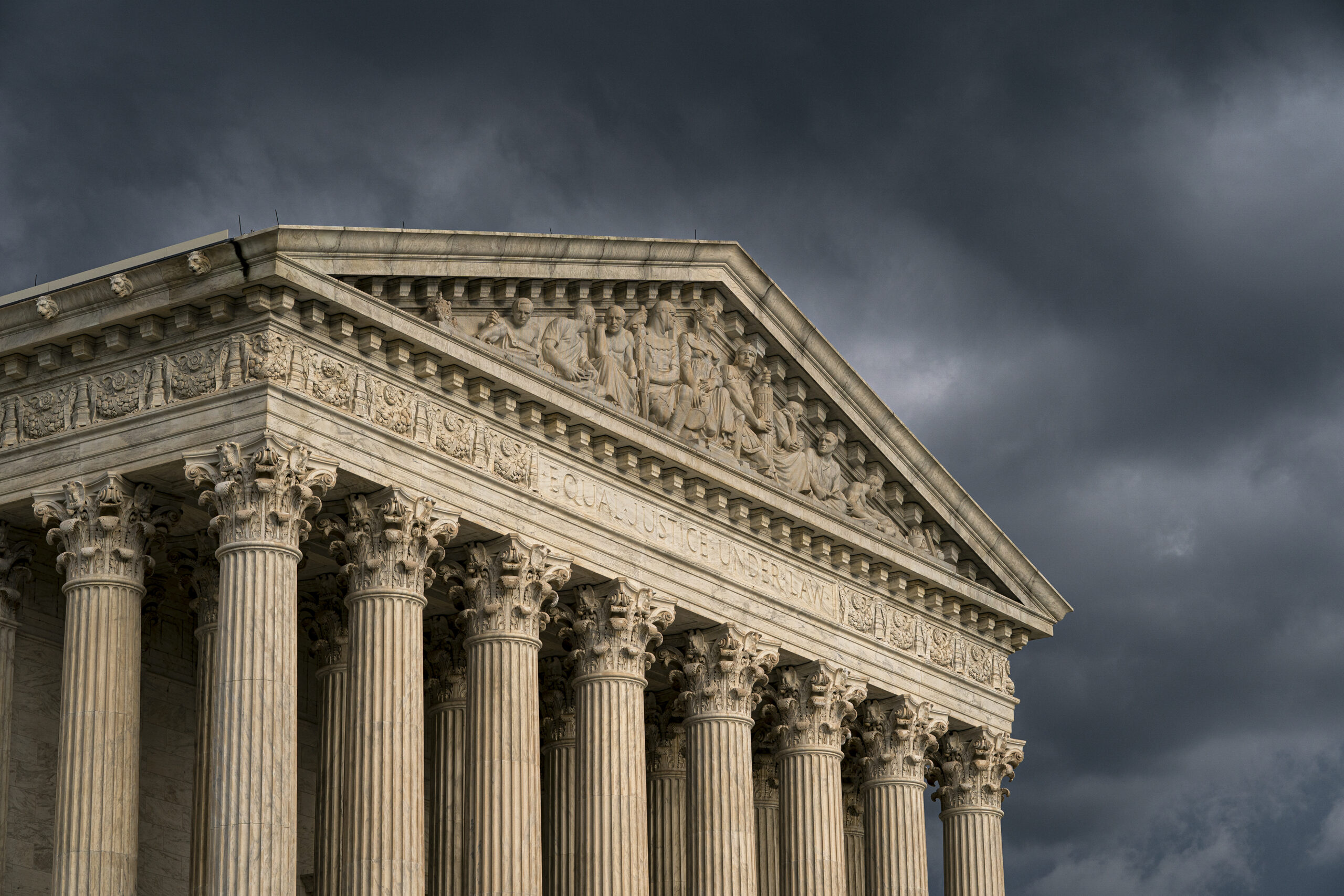 FILE - In this June 20, 2019, file photo, the Supreme Court is seen in Washington as a storm rolls in. The Supreme Court has agreed to hear an appeal to expand gun rights in the United States in a New York case over the right to carry a firearm in public for self-defense. (AP Photo/J. Scott Applewhite, File)