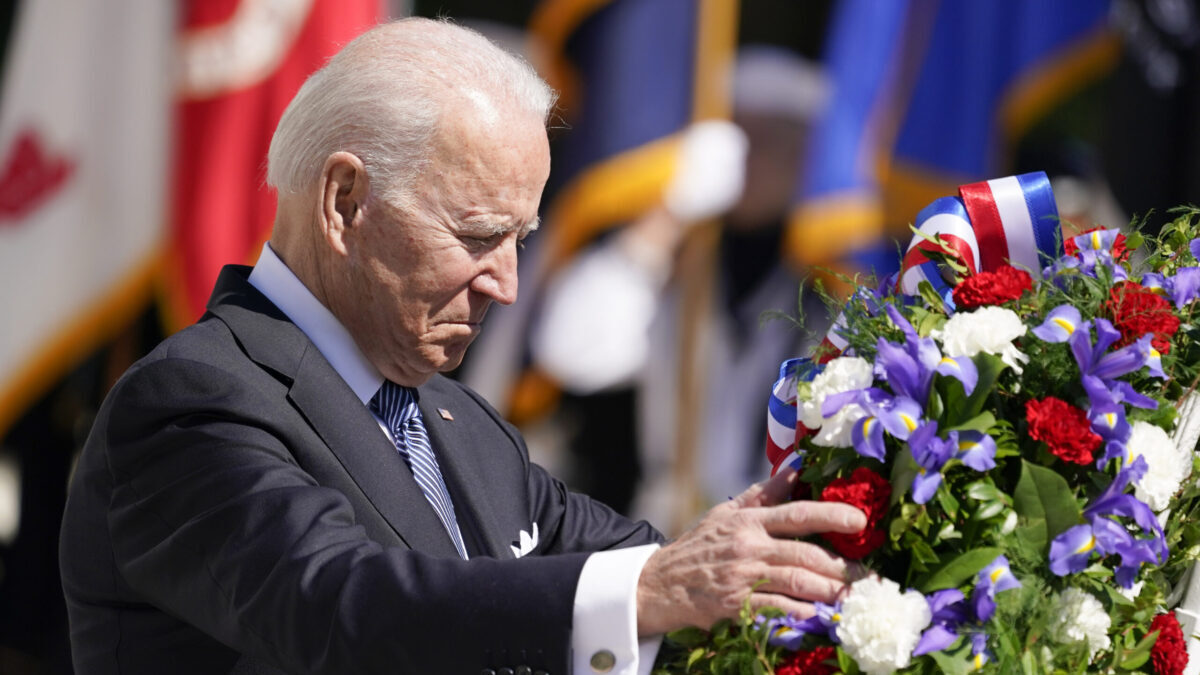 President Joe Biden adjusts a the wreath at the Tomb of the Unknown Soldier at Arlington National Cemetery on Memorial Day, Monday, May 31, 2021, in Arlington, Va.(AP Photo/Alex Brandon)