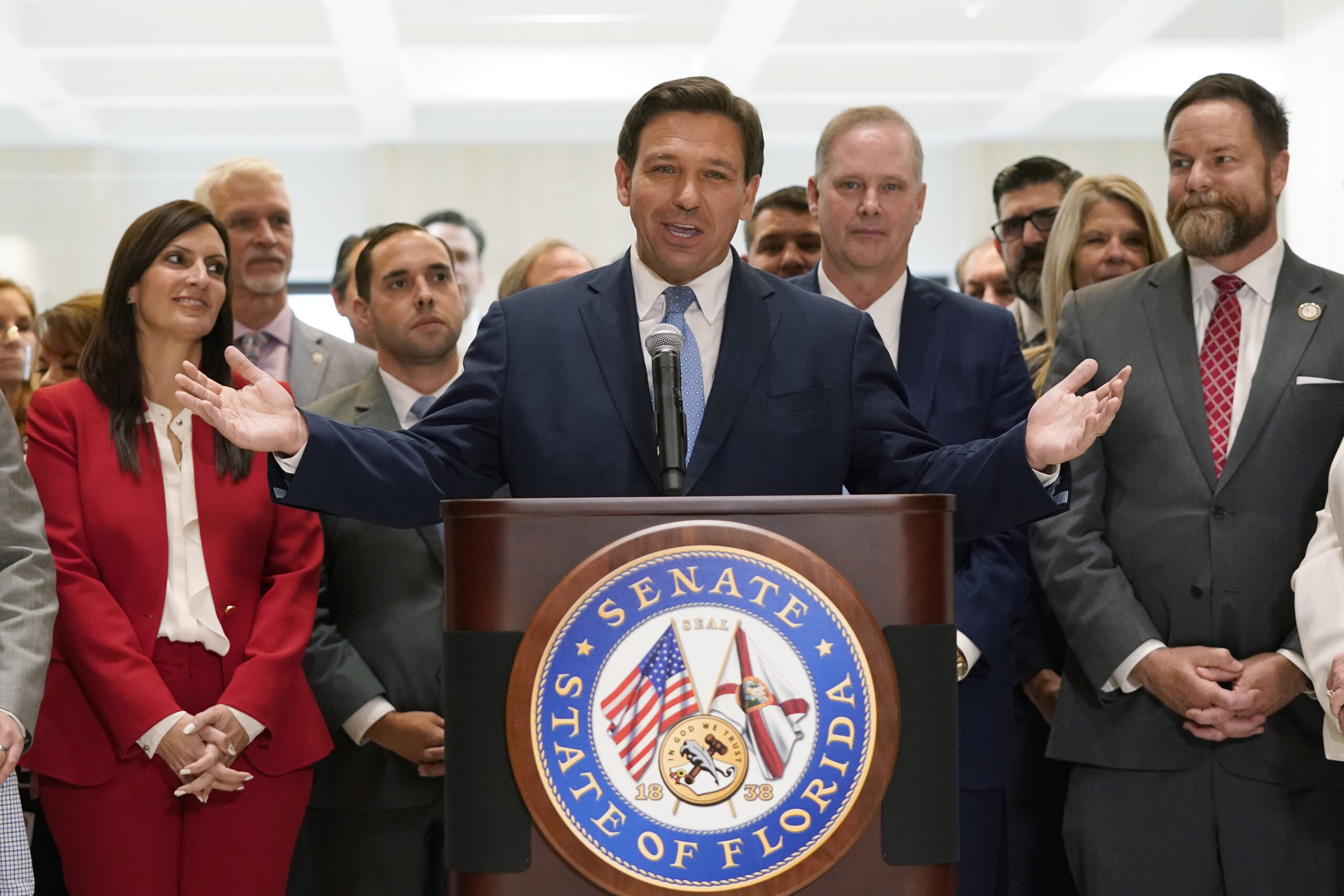 Surrounded by lawmakers, Florida Gov.Ron DeSantis speaks at the end of a legislative session, Friday, April 30, 2021, at the Capitol in Tallahassee, Fla. (AP Photo/Wilfredo Lee)