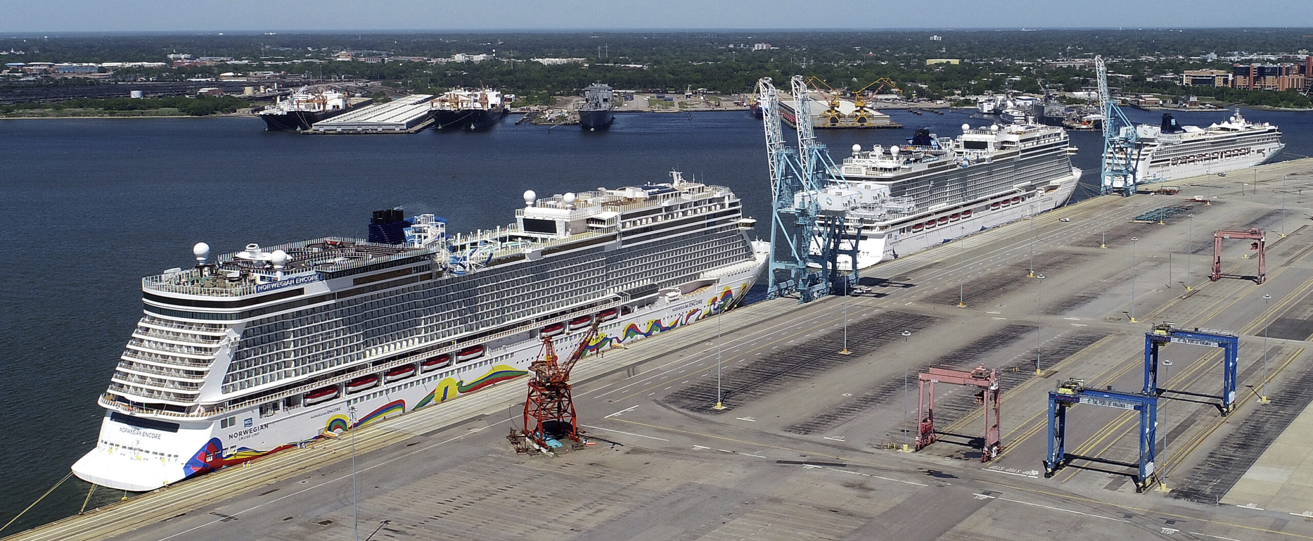 FILE - In this May 4, 2020 file photo, Norwegian cruise ships are docked at Portsmouth Marine Terminal in Portsmouth, Va. Norwegian Cruise Lines is threatening to skip Florida ports because of the governor's order banning businesses from requiring that customers be vaccinated against COVID-19. The company says Gov. Ron DeSantis' order conflicts with guidelines from federal health authorities that would let cruise ships sail in U.S. waters if passengers and crew members are vaccinated. (Stephen M. Katz/The Virginian-Pilot via AP, File)