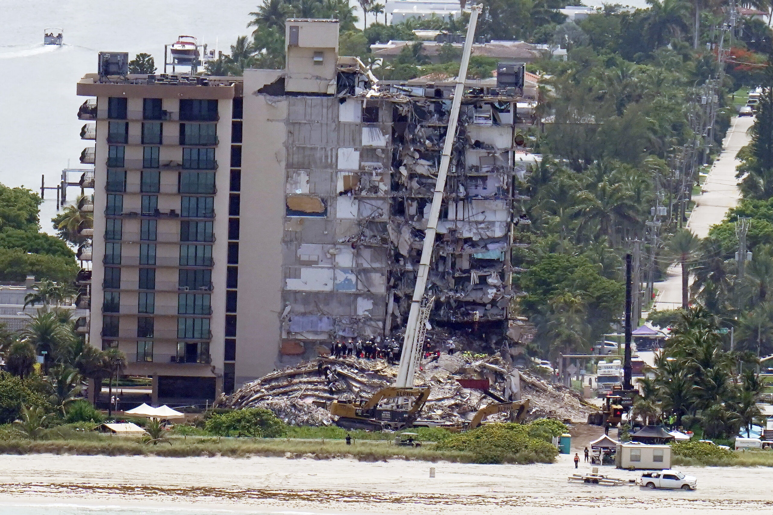 Workers search in the rubble at the Champlain Towers South Condo, Saturday, June 26, 2021, in Surfside, Fla. One hundred fifty-nine people were still unaccounted for two days after Thursday's collapse, which killed at least four. (AP Photo/Gerald Herbert)