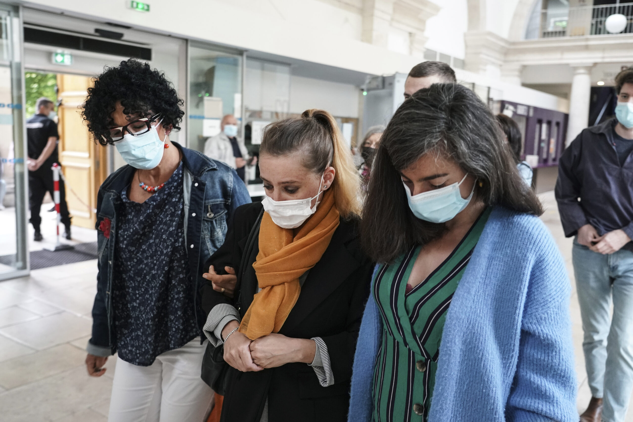Valerie Bacot, center, arrives with relatives at the Chalon-sur-Saone courthouse, central France, Thursday, June 24, 2021. Valerie Bacot is on trial in France for killing her husband after decades of sexual, physical and psychological abuse starting when she was an adolescent, in a case that has drawn broad attention and support for Bacot amid a national reckoning with long-held taboos around domestic abuse. (AP Photo/Laurent Cipriani)