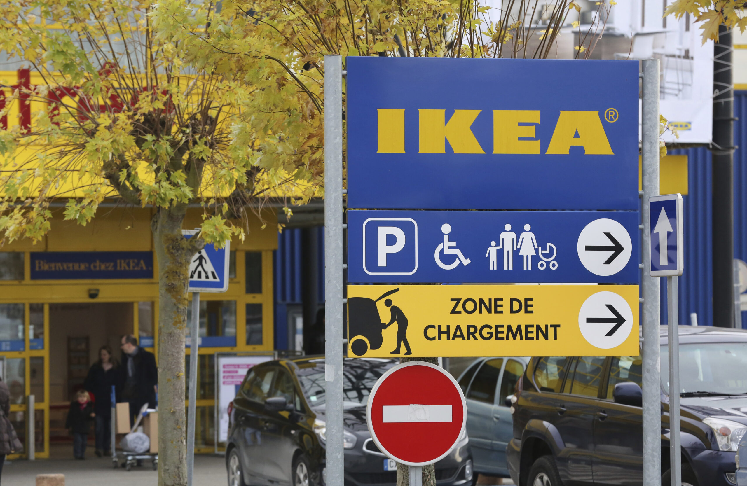 FILE - In this Wednesday, Nov. 30, 2013 file photo, customers leave an IKEA store in Plaisir, west of Paris. A French court has ordered home furnishings giant Ikea to pay more than $1.2 million in fines and damages Tuesday, June 15, 2021 over a campaign to spy on union representatives. (AP Photo/Remy de la Mauviniere, FIle)