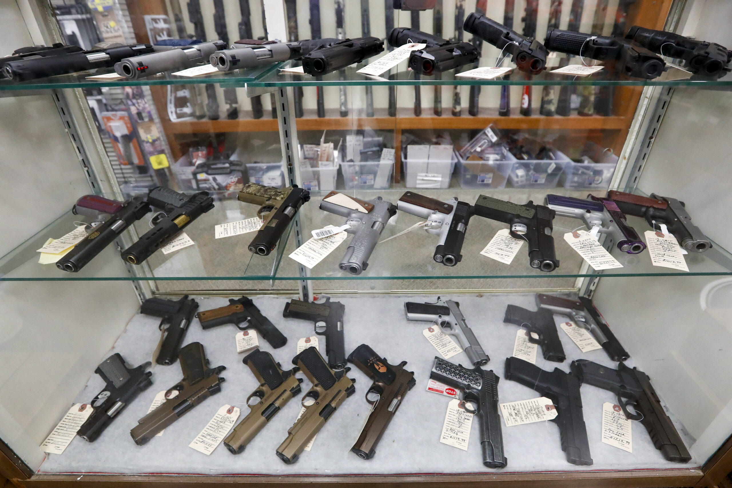 FILE - In this March 25, 2020, file photo semi-automatic handguns are displayed at shop in New Castle, Pa. The number of people stopped from buying guns though the U.S. background check system hit an all-time high of more than 300,000 last year amid a surge of firearm sales, according to new records obtained by the group Everytown for Gun Safety. The FBI numbers provided to The Associated Press show the background checks blocked nearly twice as many gun sales in 2020 as in the year before. (AP Photo/Keith Srakocic, File)